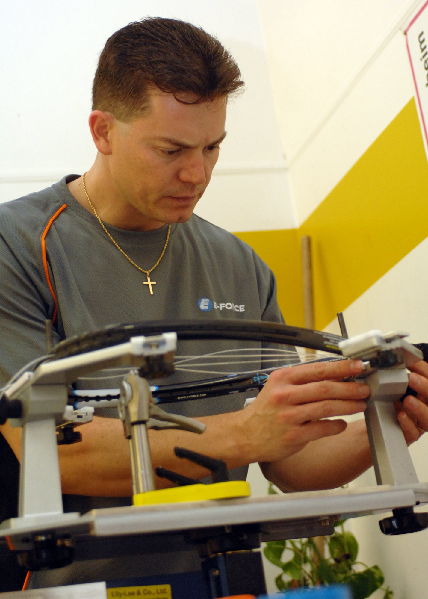 CAMPBELL BARRACKS, Germany -- Capt. Rik Lepine, 39th Information Squadron, Hurlburt Field, Florida, restrings a racquet during the Angel Tree Racquetball Tournament at Campbell Fitness Center Dec. 5, 2008. Proceeds and unwrapped gifts were donated to those in need within the local area.  (U.S. Air Force photo by Senior Airman Jenifer H.  Calhoun)