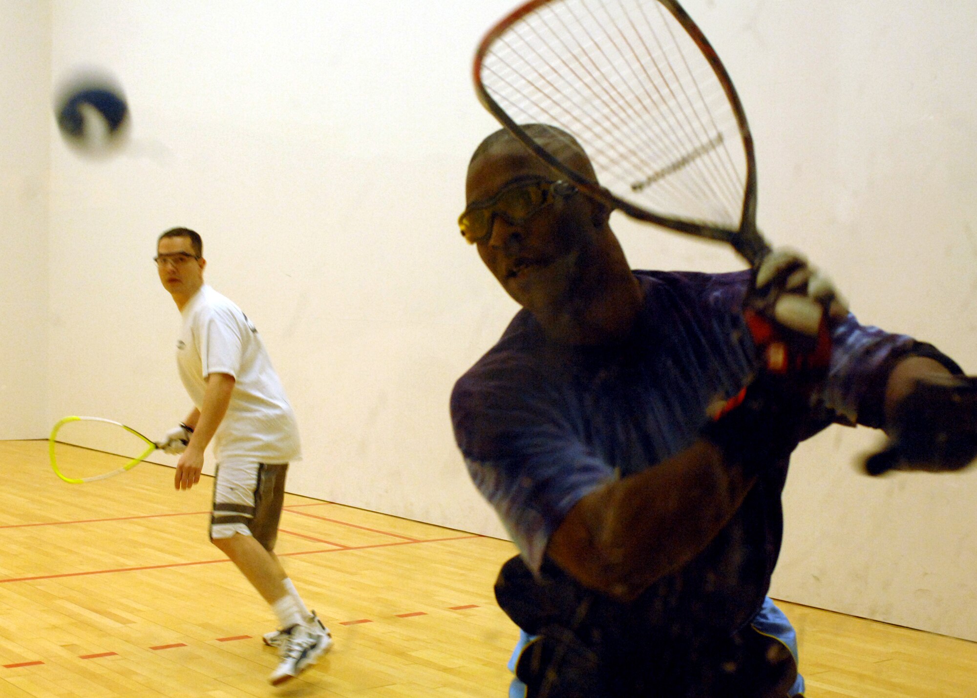 CAMPBELL BARRACKS, Germany -- Tech. Sgt. Robert Varkonyi, 52nd Communications Squadron, waits as Lt. Col. Tim Hardison, 7th Army, sets up to hit the ball during the Angel Tree Racquetball Tournament at Campbell Fitness Center Dec. 5, 2008. Proceeds and unwrapped gifts were donated to those in need within the local area.  (U.S. Air Force photo by Senior Airman Jenifer H.  Calhoun)