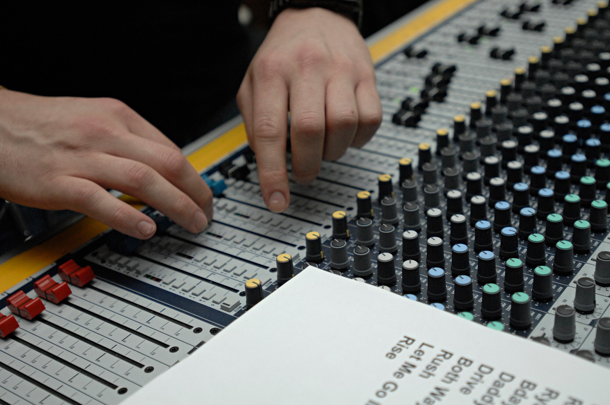 Quietdrive’s sound technician, Robert Conner, reviews the set list and adjusts the soundboard for the next song during the 2009 New Year’s Eve Bash hosted by the Incirlik Consolidated Club, Dec. 31. Quietdrive visited Incirlik as part of their Armed Forces Tour. (U.S. Air Force photo/Senior Airman Benjamin Wilson)