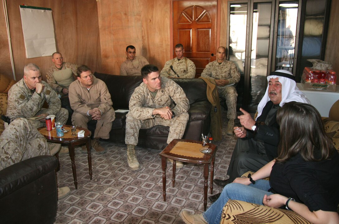 Capt. William Steuber (center), the 2nd Battalion, 25th Marine Regiment’s lines of operation (LOO) manager, facilitates at a meeting between Coalition leaders and Sheik Fadil Isma’il, a Rutbah-area tribal leader and city councilman, during the sheik’s visit to Camp Korean Village, Iraq, Jan. 3.  As the LOO manager, Steuber works hand-in-hand with Jerry Calhoun (left of Steuber), a senior governance advisor and embedded provincial reconstruction team leader for the United States Agency for International Development, a federal organization which is currently operating in Iraq under the direction of the U.S. State Department.  Official USMC photo by Capt. Paul L. Greenberg