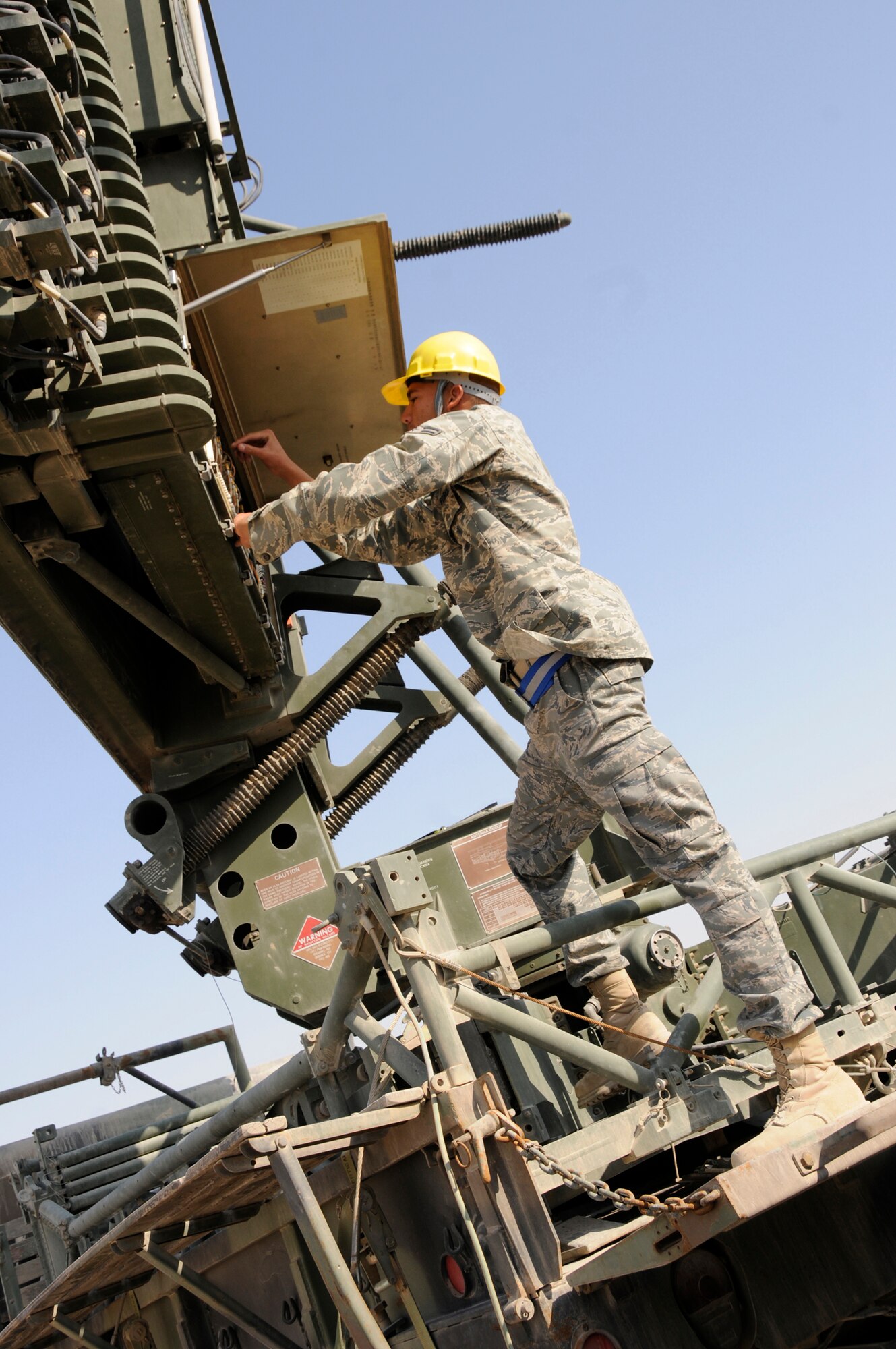 Airman 1st Class William Lundy, a radar maintenance technician assigned to the 71st Expeditionary Air Control Squadron, adjusts the receiver assembly here Tuesday. The radar maintenance team assures the radars remain in good working condition and calibration.  The radars provide an extensive radar presence over the entire Arabian Gulf region. They track every aircraft in the sky, with the detailed information; the 71 EACS team is able to distinguish the flight characteristics of any aircraft flying within range, which allows a determination if a plane is friendly or foe. (U.S. Air Force photo by Tech. Sgt. Michael Boquette)