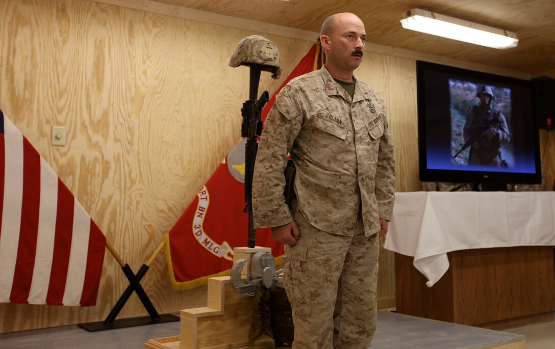 Chief Warrant Officer 3 Kelly J. Colton, company commander of 1st Explosive Ordnance Disposal Company, 1st Marine Logistics Group (Forward) participates in a memorial service for Staff Sgt. Jordan Emrick at Camp Leatherneck, Afghanistan, Nov. 13. Emrick, an EOD tech assigned to 3rd Platoon, 1st EOD Company, 1st MLG (FWD), was killed Nov. 5 while conducting combat operations in Helmand province, Afghanistan.