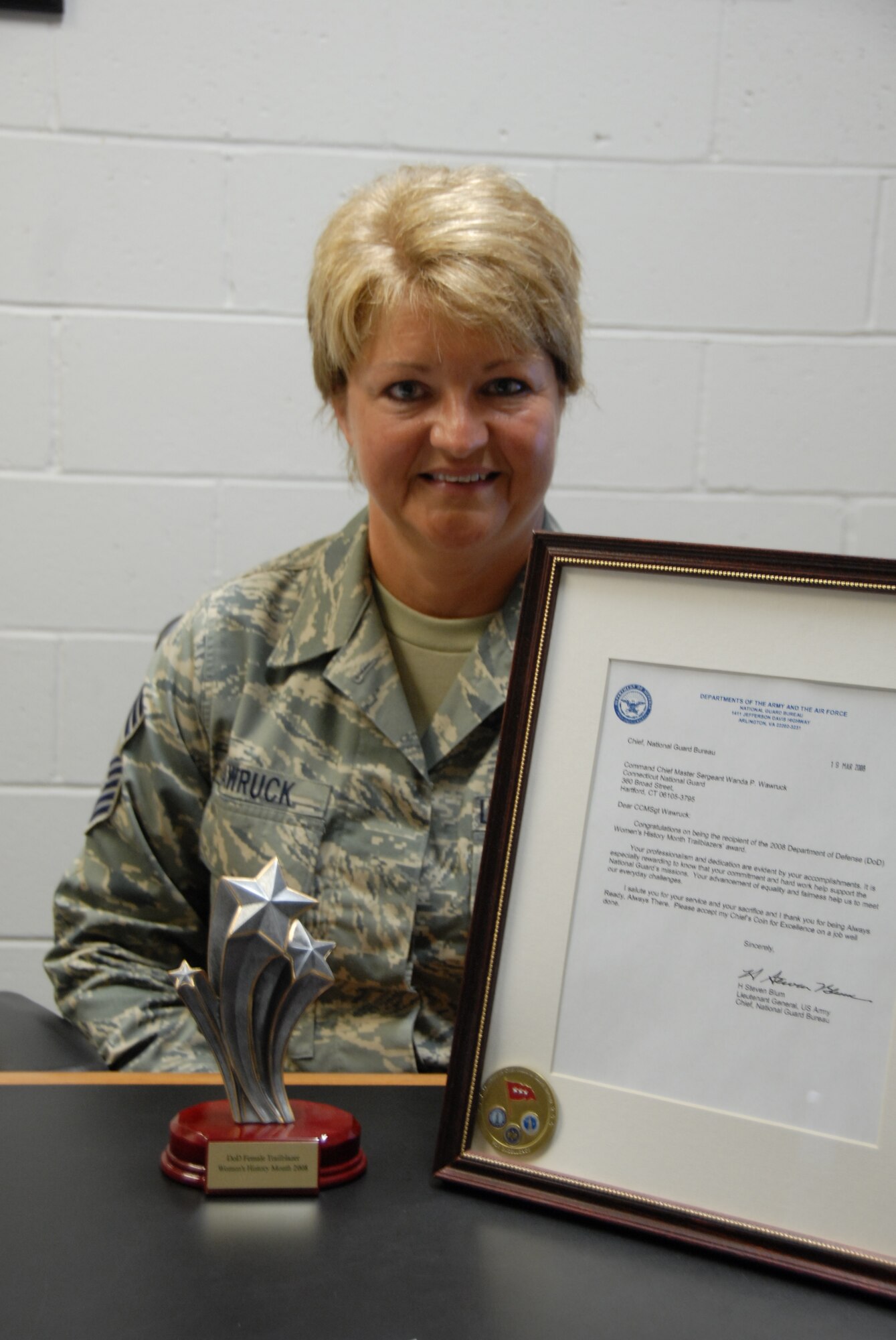 Chief  Master Sgt. Wanda Wawruck, 103rd Airlift Wing personnel superintendant, proudly displays the Department of Defense Trailblazer Award September 17, 2008, at the Bradley Air National Guard Base, East Granby, Connecticut.  Wawruck was formally recognized for her exceptional career achievements and presented the award during a March 2008 reception at the Women's Art Museum in Washington, D.C.  (U.S. Air Force photo by Staff Sgt. Erin McNamara) 