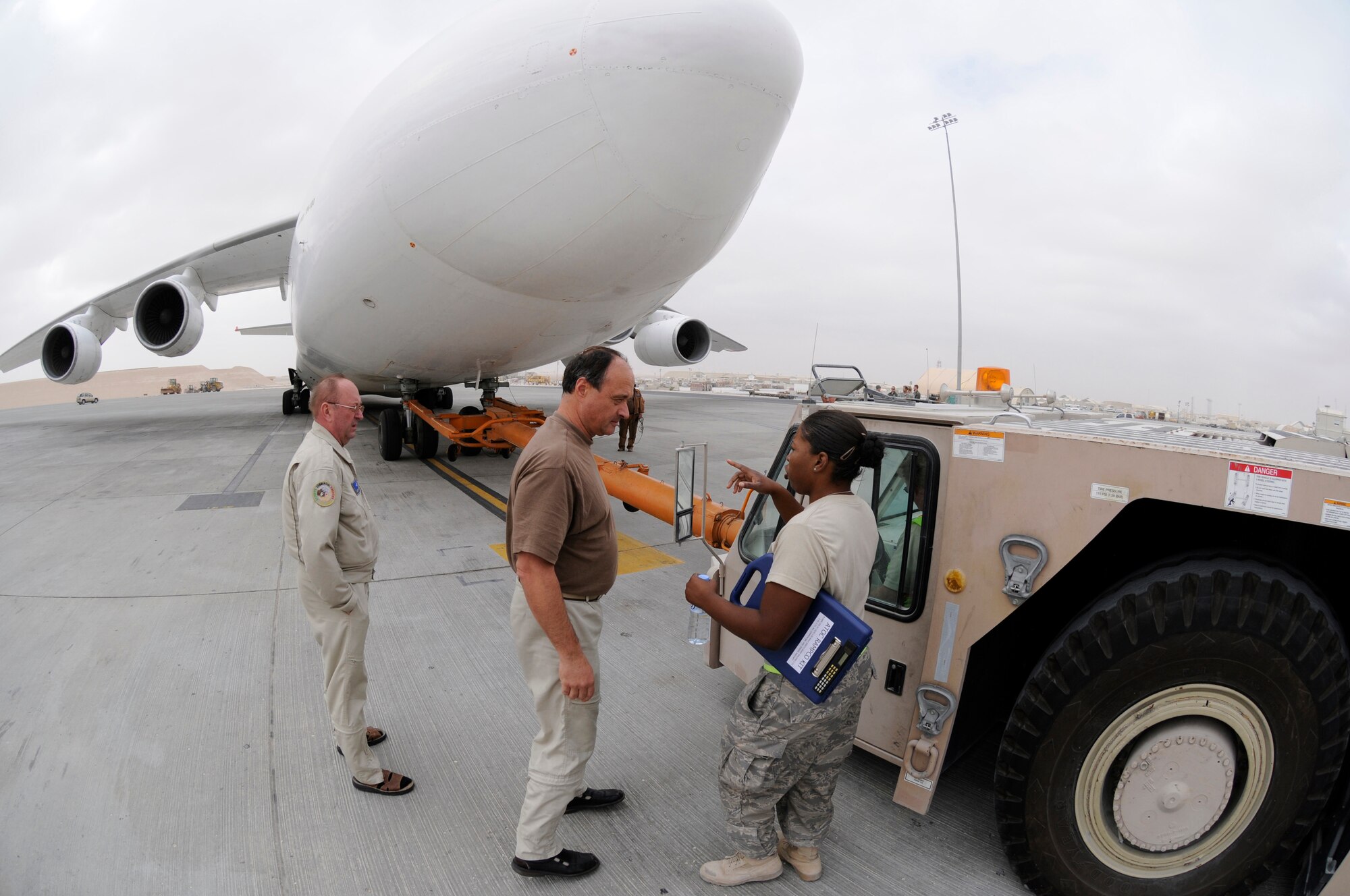 Airman 1st Class Candace Reese, a ramp controller assigned to the 8th Expeditionary Air Mobility Squadron, coordinates movement of a Russian Antonov 124-100 heavy lift cargo aircraft, Jan. 2, 2009, at an undisclosed air base in Southwest Asia.  Airman Reese is the liaison between the aircrew and the transient alert technician.  After loading 7 pallets of equipment and supplies, the plane had to be repositioned to load a heavy equipment vehicle. The equipment and supplies are being delivered farther into the Central Command area of responsibility in support of operations in Afghanistan.  Airman Reese is a native of St. Louis, Mo., and is deployed from Charleston Air Force Base, S.C., in support of Operations Iraqi and Enduring Freedom and Joint Task Force-Horn of Africa.  (U.S. Air Force photo by Tech. Sgt. Michael Boquette/Released)