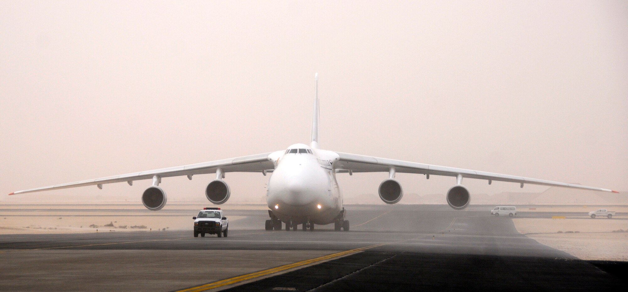 A Russian Antonov 124-100 heavy lift cargo aircraft is led to a parking spot, Jan. 2, 2009, at an undisclosed air base in Southwest Asia.  The Antonov aircraft has arrived to pick up supplies and a heavy equipment vehicle for transport further into the Central Command area of responsibility to support Global War on Terror operations in Afghanistan.  (U.S. Air Force photo by Tech. Sgt. Michael Boquette/Released)