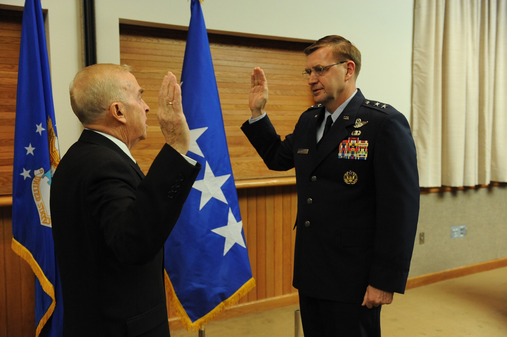 Maj. Gen. Stephen Hoog, U.S. Air Force Warfare Center commander, is sworn in by retired Gen. Jack Gregory during his pin-on ceremony at Nellis Air Force Base, Nev., Dec. 22, 2008. (U.S. Air Force photo/Senior Airman Brian Ybarbo)