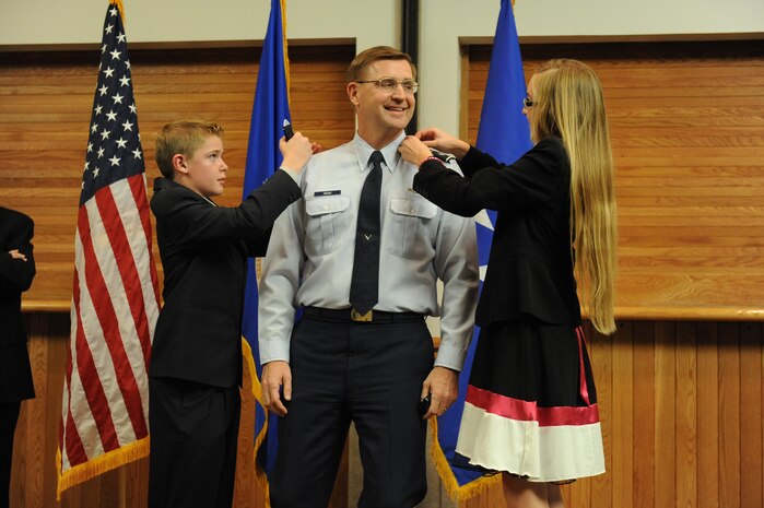Maj. Gen. Stephen Hoog, U.S. Air Force Warfare Center commander, is pinned on by his son, Christopher, and his daughter, Sophia, at Nellis Air Force Base, Nev., Dec. 22, 2008. (U.S. Air Force photo/Senior Airman Brian Ybarbo)