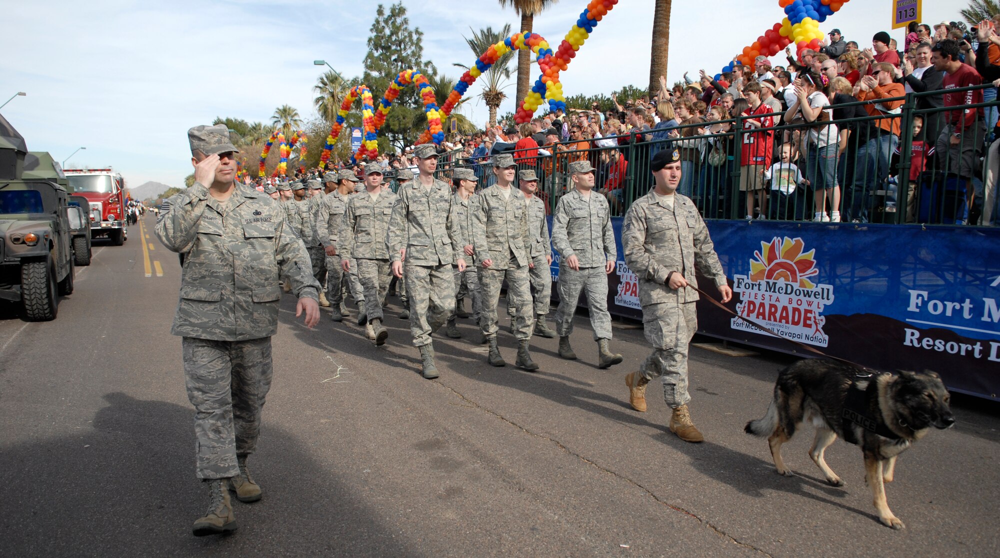 Chief Master Sgt. Randy Raper, 56th Fighter Wing command chief, leads a formation of Airmen through downtown Phoenix during the 38th Annual Fiesta Bowl Parade Jan. 3. More than 100 Airmen participated in the event which is part of Phoenix's Fiesta Bowl event schedule including the Insight Bowl game in Tempe, for which Luke F-16s performed a fly-over and the Fiesta Bowl game itself in which Luke Airmen will be honored. (U.S. Air Force photo/Master Sgt. William Gomez)
