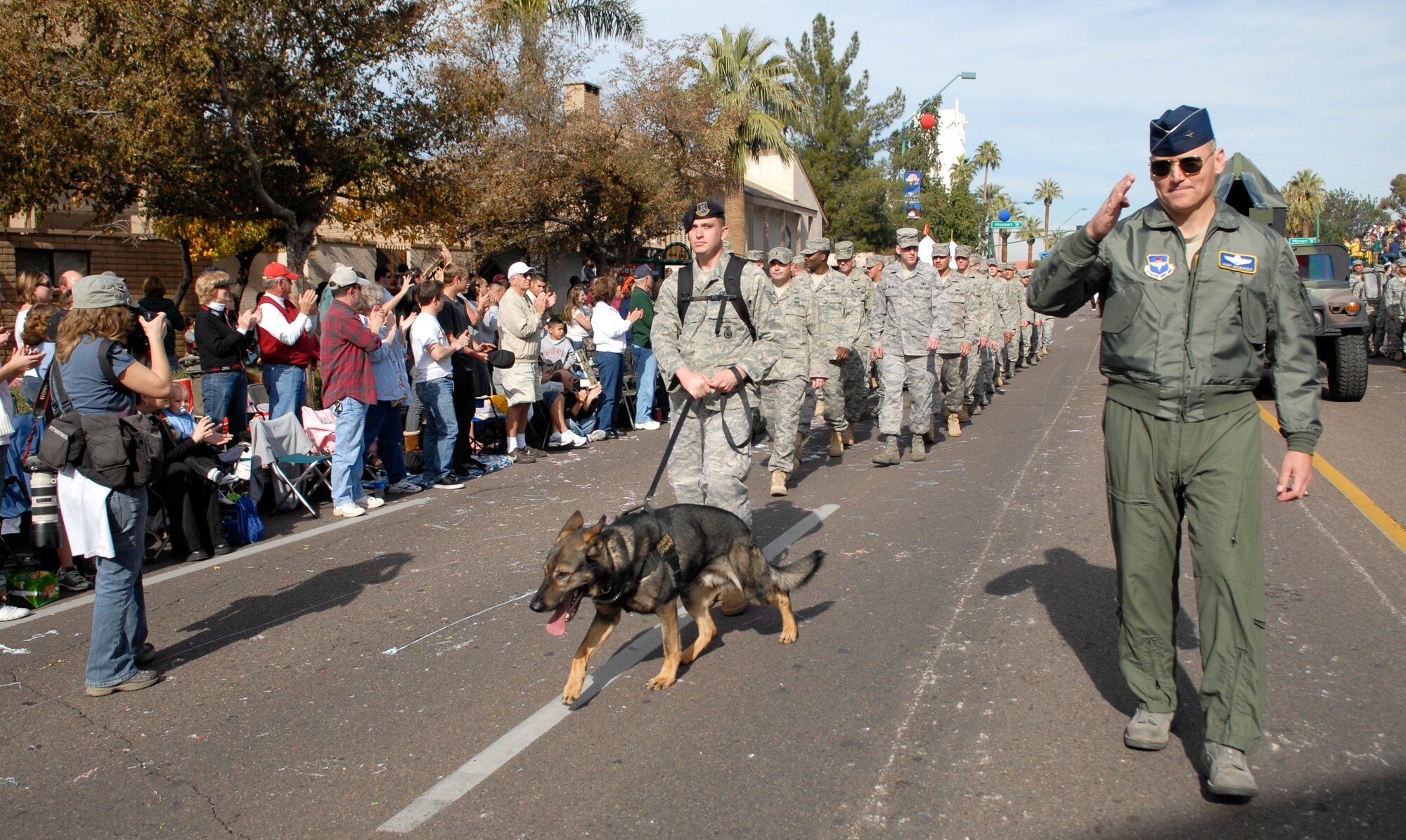 Brigadier Gen. Kurt Neubauer, 56th Fighter Wing commander, leads a group of Luke Airmen through downtown Phoenix during the 38th Annual Fiesta Bowl Parade Jan. 3. More than 100 Airmen participated in the event which is part of Phoenix's Fiesta Bowl event schedule including the Insight Bowl game in Tempe, for which Luke F-16s performed a fly-over and the Fiesta Bowl game itself in which Luke Airmen will be honored. (U.S. Air Force photo/Master Sgt. William Gomez)
