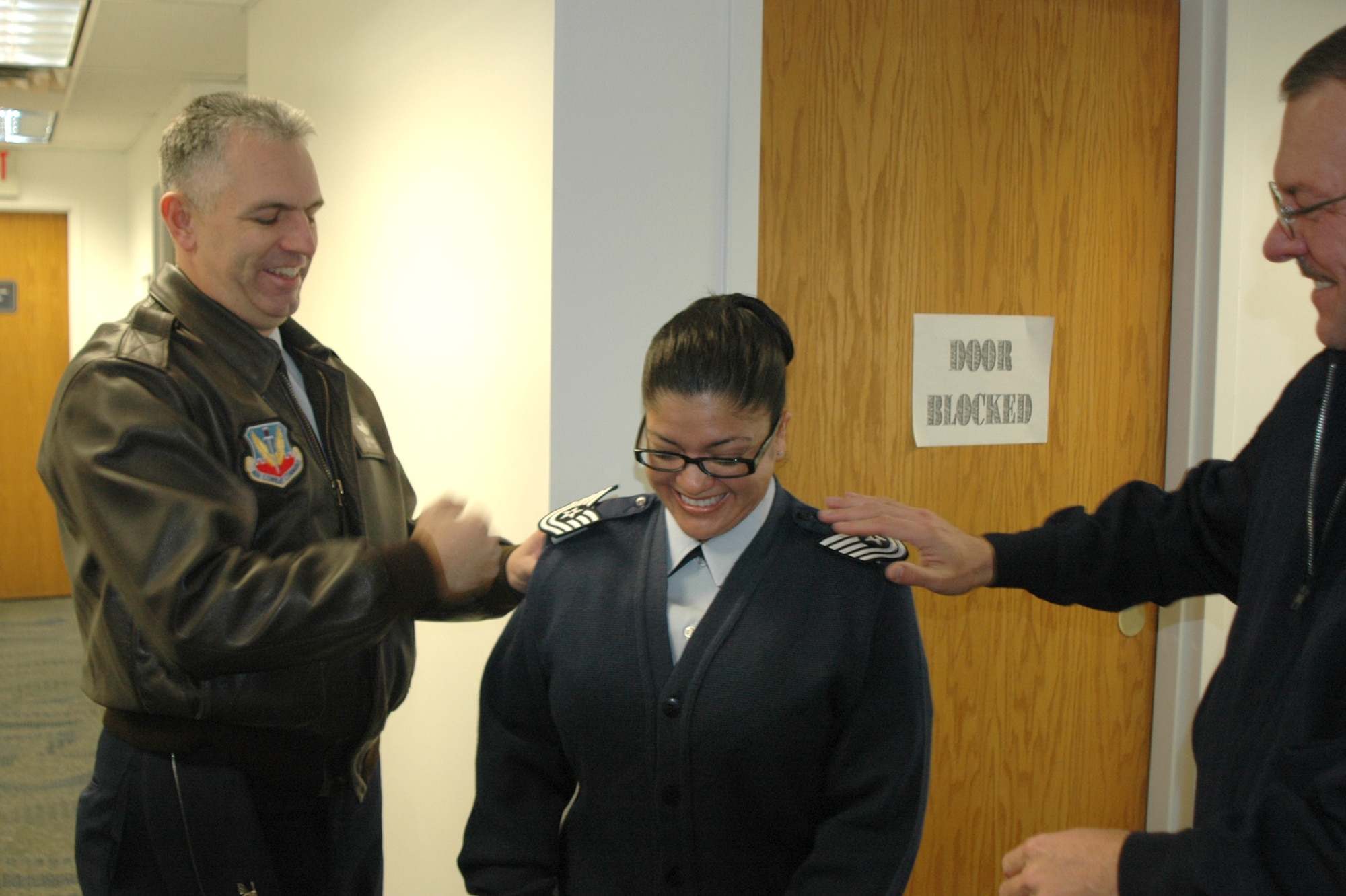 Col. Scott Dennis, 388th Fighter Wing Commander, and Chief Master Sgt. Kenneth Czop, 388th FW command chief, promote Staff Sgt. Maria Badure, 388th Maintenance Operations Squadron Information Manager, to the rank of technical sergeant through the Stripes for Exceptional Performers program Jan. 5. 
