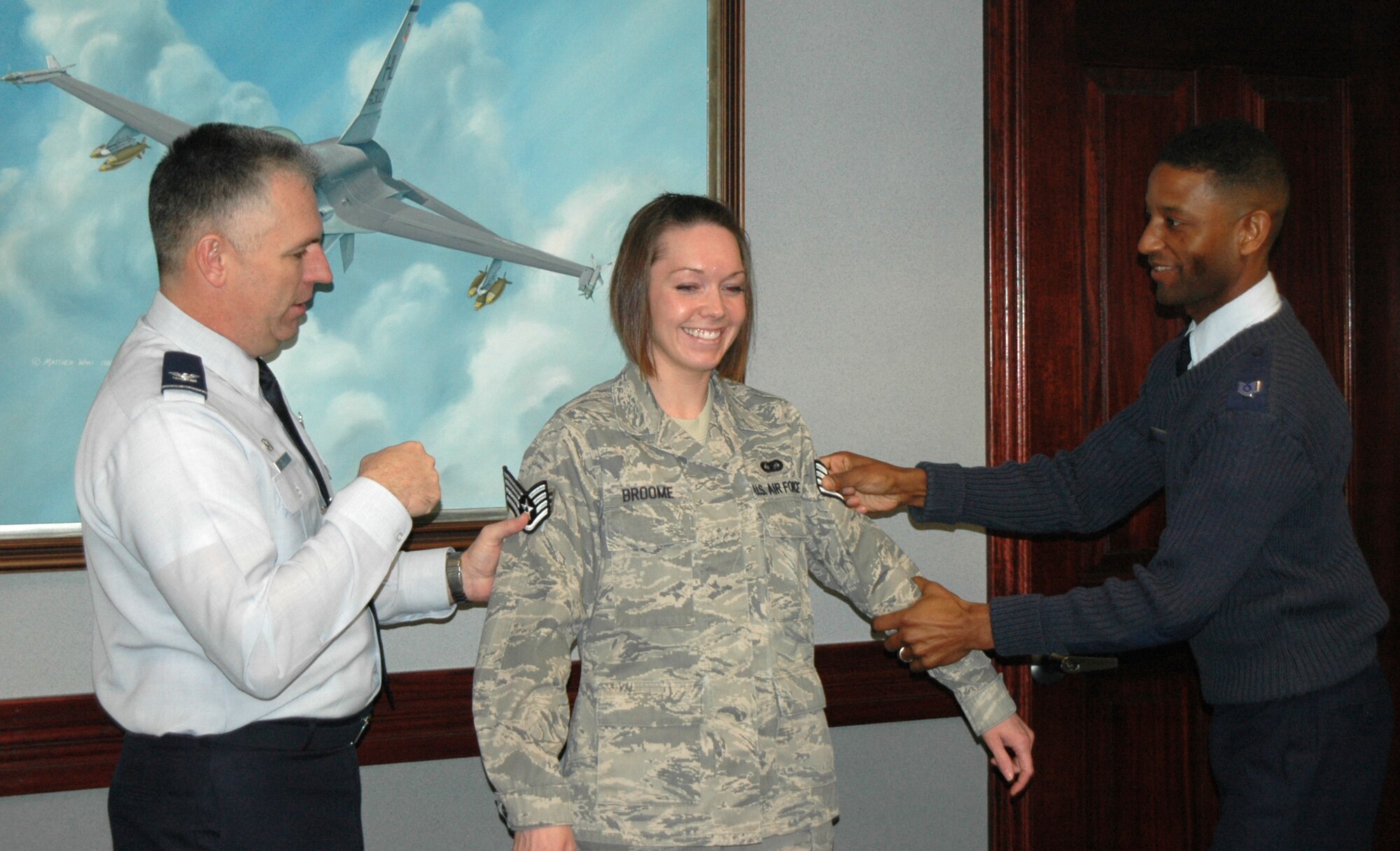 Col. Scott Dennis, 388th Fighter Wing Commander, and Tech. Sgt. Gerald Holden, 388th FW Non-Commissioned Officer in Charge of Information Management, promote Senior Airman Jessica Broome, 388th FW Information Manager, to the rank of Staff Sgt. through the Stripes for Exceptional Performers program Jan. 5.