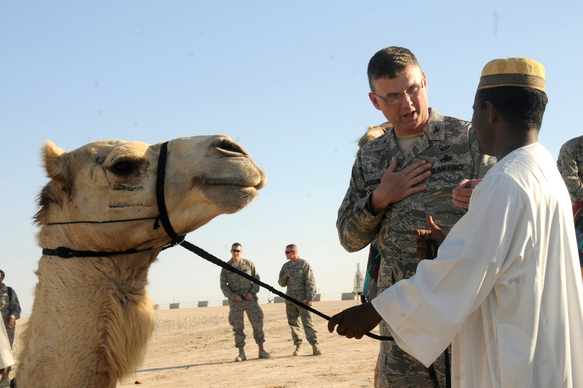 Col. Donald Dickerson talks to a local national Dec. 23 at an air base in Southwest Asia. Colonel Dickerson is the 379th Air Expeditionary Wing Host Nation Coordination Cell director. He is a native of Roanoke, Va., and is deployed from Travis Air Force Base, Calif. (U.S. Air Force photo/Staff Sgt. Darnell T. Cannady) 
