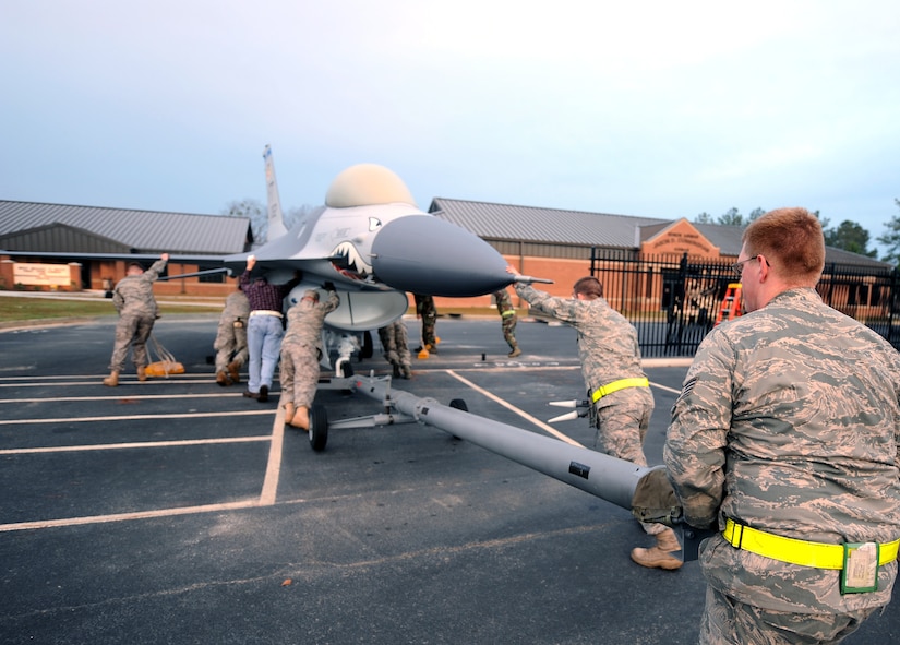 MOODY AIR FORCE BASE, Ga. – Airmen from the 23rd Equipment Maintenance Squadron pushes an F-16C Fighting Falcon through the professional development center gates here Jan 4. The F-16C static display came to Moody because of a Base Realignment and Closure initiative that brought the Flying Tigers here. (U.S. Air Force photo by Airman Joshua Green)