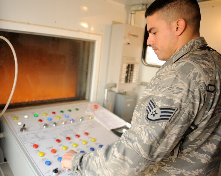 BAGHDAD, Iraq -- Staff Sgt. Jorge Arce, project manager for the department of public works, monitors the control panel of a mobile live fire training unit during an exercise in Baghdad, Iraq, on Dec. 24. Arce is deployed from the 23rd Civil Engineer Squadron, Moody Air Force Base, Ga. (U.S. Air Force photo/Staff Sgt. Paul Villanueva II) 