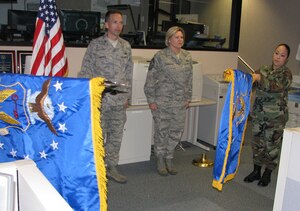 Col, James Marrs, commander 480th Intelligence, Surveillance and Reconnaissance Wing (left), presides over the midnight name-change ceremony where the new flag (left) of the 480th ISR Wing is unfurled and the old 480th Intelligence Wing flag is rolled up New Year's Eve.  The name change marks the culmination of the 480th ISR Wing reallignment under the AIr Force ISR Agency. (US Air Force photo/Staff Sgt. Michael Edmond)