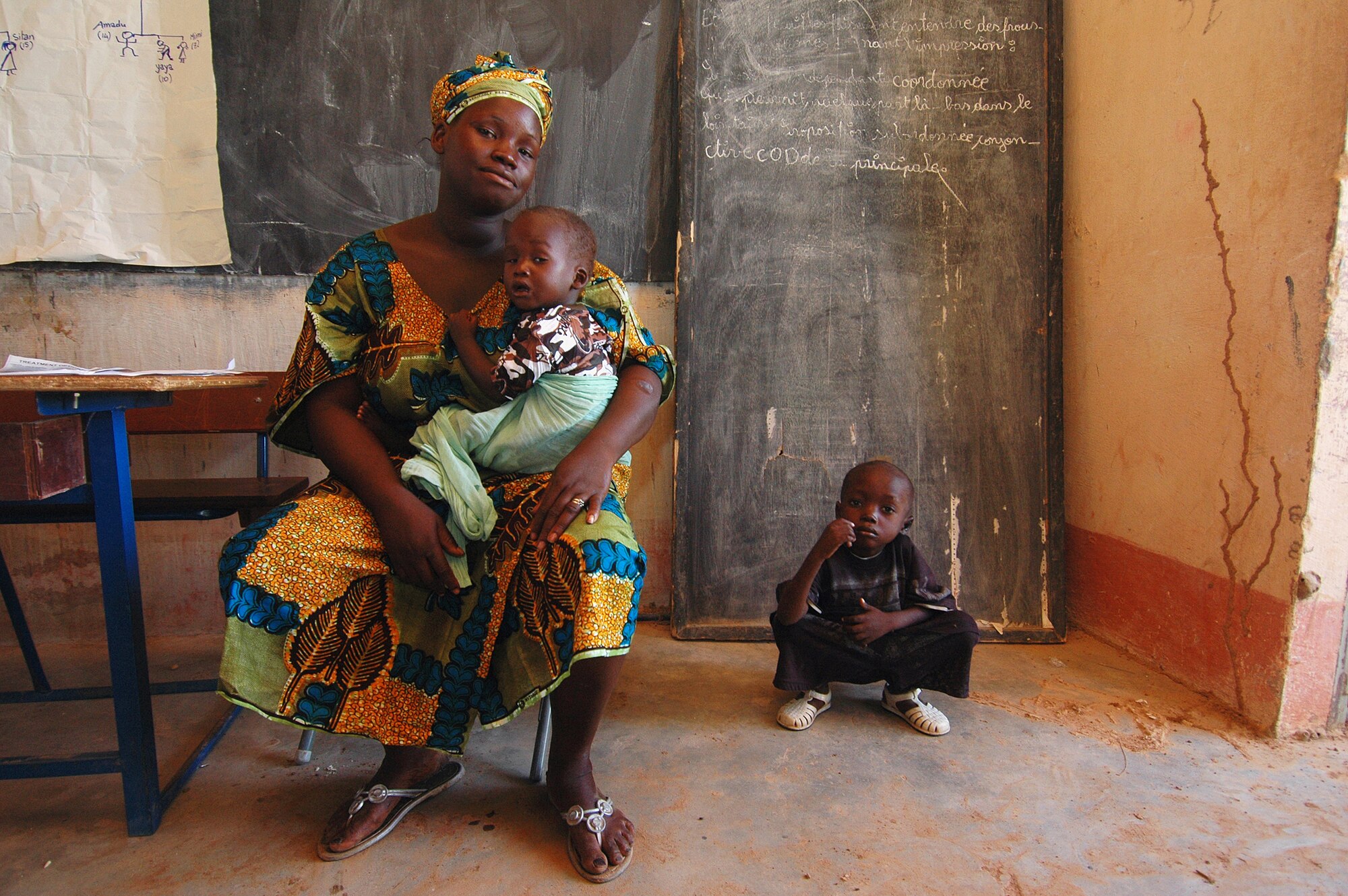 BAMAKO, Mali -- A Malian mother and her two children wait to be seen by a doctor during a humanitarian clinic in the village of Droit June 22. Droit was one of four villages the MEDFLAG team visited during a series of humanitarian outreach visits.  (U.S. Air Force photo/Senior Airman Justin Weaver)