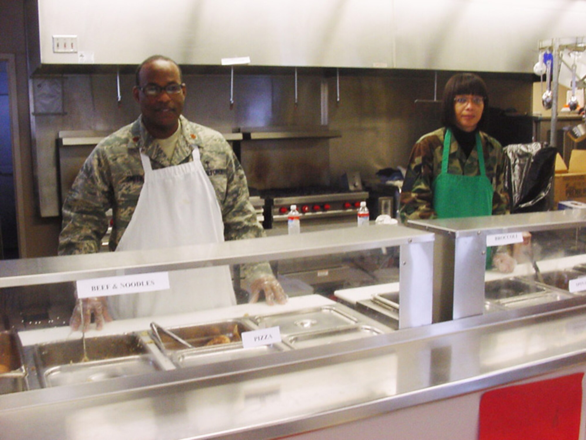 GRISSOM AIR RESERVE BASE, Ind., -- Chaplain (Maj) Obadiah Smith, Jr., (left) and Master Sgt. Trudy Burnett of the 434th Air Refueling Wing Chaplain's Office volunteer their off-duty time to assist at the Kokomo Rescue Mission.   Chaplain Smith and Sergeant Burnett helped to serve 100 meals at the mission during the holiday season. (Courtesy photo)