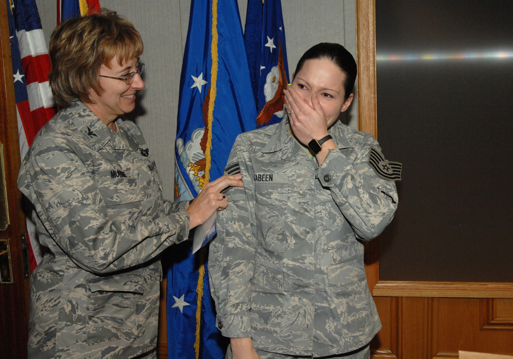 Col. Eden J. Murrie, 100th Air Refueling Wing commander, promotes Staff Sgt. Abbi Cabeen to the rank of technical sergeant under the Stripes for Exceptional Performers program Dec. 19 in the wing conference room. Sergeant Cabeen is the executive assistant to the 100th Air Refueling Wing command chief master sergeant. The STEP program is a highly visible promotion recognition program used by commanders at all levels to recognize the outstanding contributions and accomplishments of senior airmen, staff sergeants and technical sergeants. (U.S. Air Force photo by Senior Airman Teresa Hawkins)