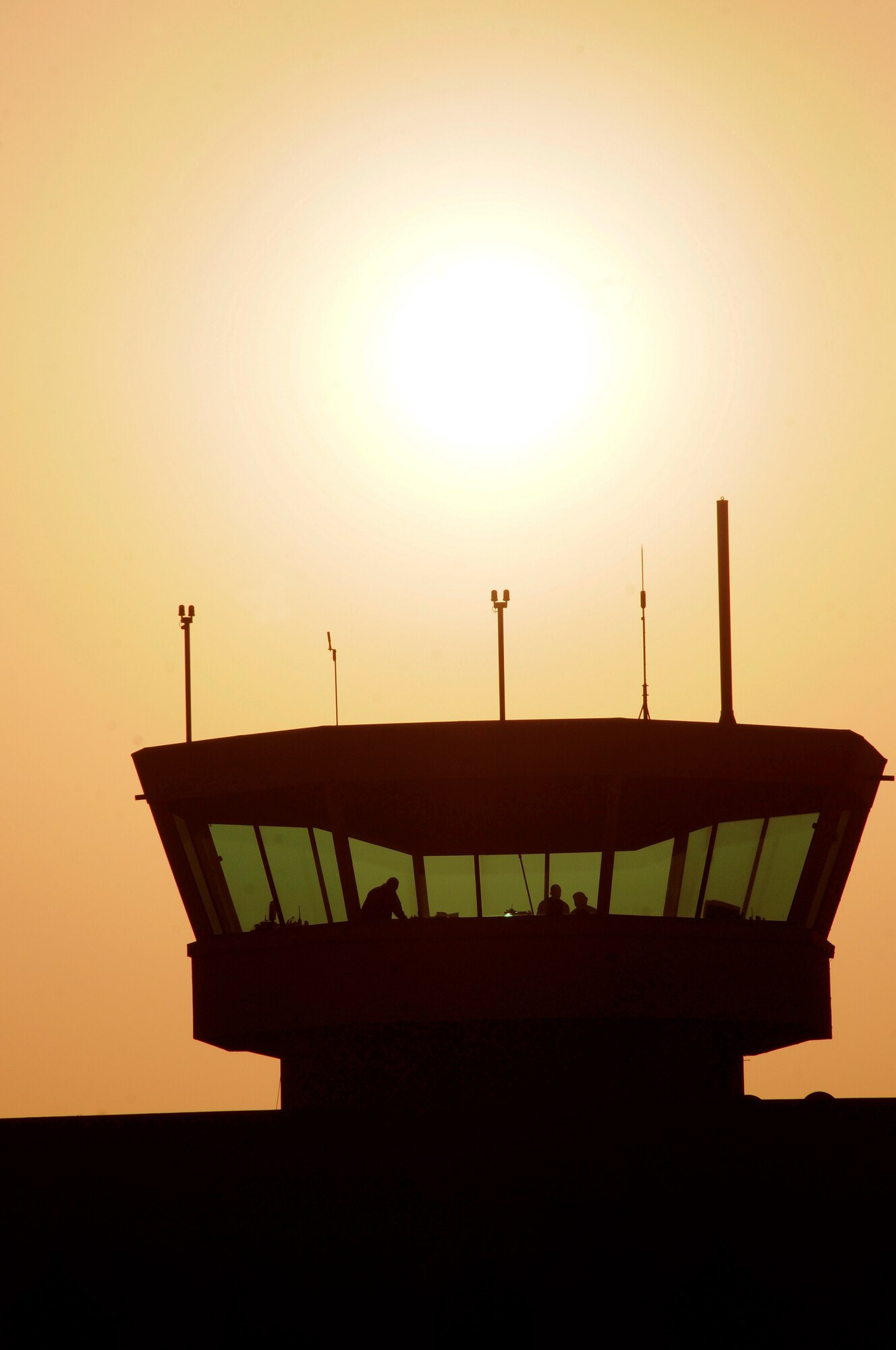As the sun sets on another day, the air traffic controllers assigned to the 379th Expeditionary Operations Group, continue to keep watch over the skies, Jan. 4, 2009, at an undisclosed air base in Southwest Asia. The Controllers keep track of all aircraft approaching or departing the base, as well as directing all aircraft movement on the ramps and taxiways.  The aircraft under their control are directly supporting Operations Iraqi and Enduring Freedom and Joint Task Force-Horn of Africa.  (U.S. Air Force photo by Tech. Sgt. Michael Boquette/Released)