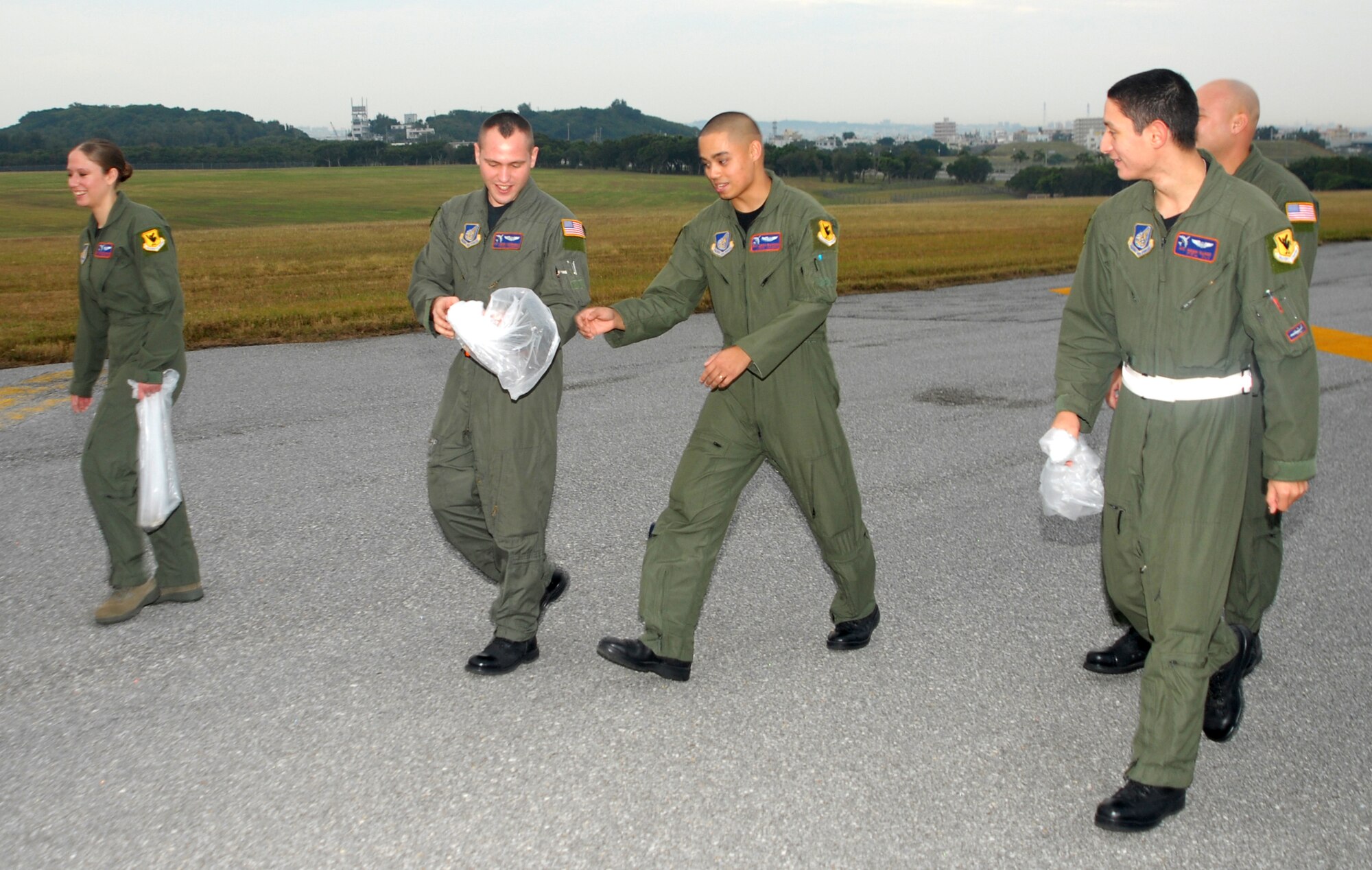 Crew members from the 961st Airborne Air Control Squadron gather pieces of foreign object debris (FOD) during the annual Team Kadena FOD Walk Jan. 5.  FOD damage costs millions of dollars in parts and repairs to Air Force aircraft every year.
(U.S. Air Force photo/Staff Sgt. Nestor Cruz)
