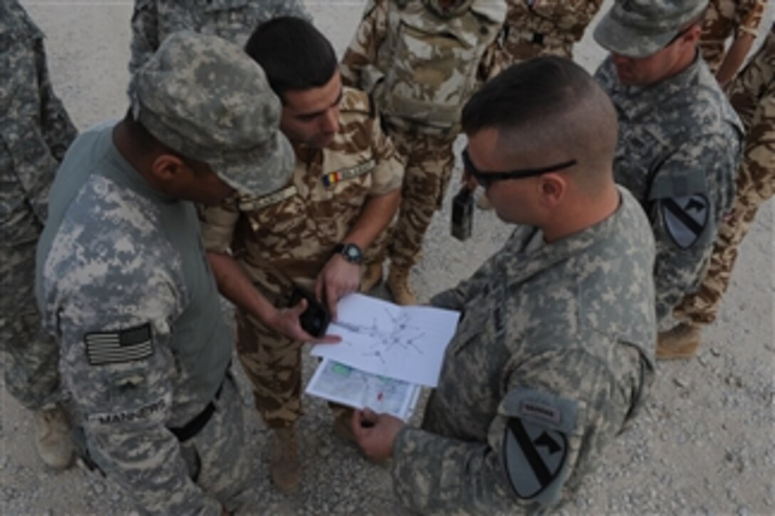 Romanian, Iraqi and U.S. soldiers collaborate during a joint patrol outside of Combat Operations Base Adder, Iraq, on Dec. 30, 2008.  The U.S. soldiers are with the 443rd Military Transition Team and the Combat Observation Lazing Team from 4th Brigade Combat Team, 1st Cavalry Division.  The Iraqi soldiers are from the 10th Iraqi Army Division and the Romanian soldiers are from the 341st Battalion (White Sharks).  