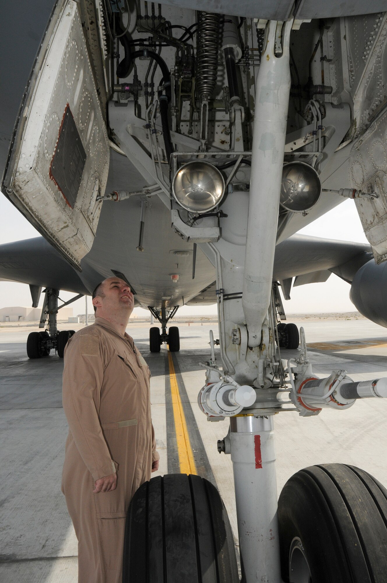 SOUTHWEST ASIA -- Master Sgt. Clifford Hughes from the 908th Expeditionary Air Refueling Squadron performs a preflight scan here Jan. 3. This is an outside the aircraft scan to ensure there is nothing abnormal with the aircraft. He is looking for leaks and missing or loose components. Sergeant Hughes has flown over 300 combat missions, in 7 years of deploying. He has deployed nearly 800 days. Six of the deployments were with the MH-53M Pavelow and three on the KC-10 A Extender. Sergeant Hughes is deployed from the 2nd ARS McGuire Air Force Base, N.J., his hometown is Goshen, Ohio. (U.S. Air Force photo/Tech. Sgt. Christopher A. Campbell) (released)