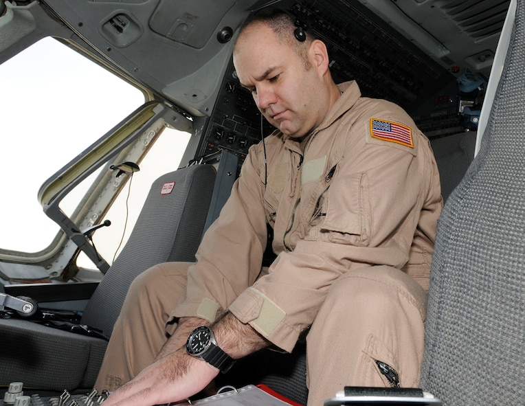 SOUTHWEST ASIA -- Master Sgt. Clifford Hughes from the 908th Expeditionary Air Refueling Squadron aligns the aircraft navigation systems here Jan. 3. He is also turning on the navigation radios and checking the status of the associated systems. Sergeant Hughes has flown over 300 combat missions, in 7 years of deploying. He has deployed nearly 800 days. Six of the deployments were with the MH-53M Pavelow and three on the KC-10 A Extender. Sergeant Hughes is deployed from the 2nd ARS McGuire Air Force Base, N.J., his hometown is Goshen, Ohio. (U.S. Air Force photo/Tech. Sgt. Christopher A. Campbell) (released)