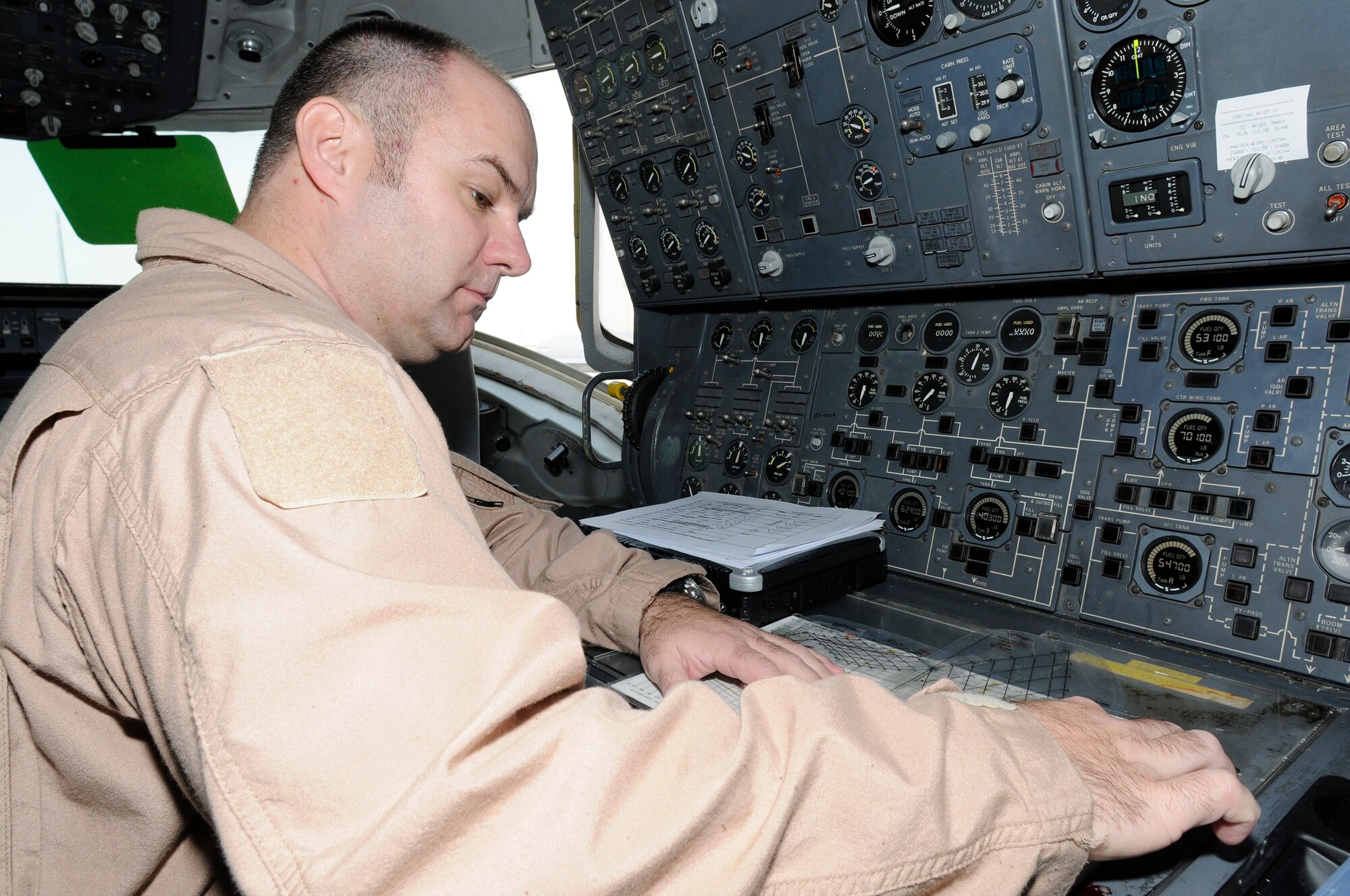 SOUTHWEST ASIA -- Master Sgt. Clifford Hughes from the 908th Expeditionary Air Refueling Squadron uses a fuel vectoring chart here Jan. 3. The chart is used to show what the aircraft center of gravity is with the fuel load. This is important so they can monitor the center of gravity as the fuel is being offloaded in flight. Sergeant Hughes has flown over 300 combat missions, in 7 years of deploying. He has deployed nearly 800 days. Six of the deployments were with the MH-53M Pavelow and three on the KC-10 A Extender. Sergeant Hughes is deployed from the 2nd ARS McGuire Air Force Base, N.J., his hometown is Goshen, Ohio. (U.S. Air Force photo/Tech. Sgt. Christopher A. Campbell) (released)