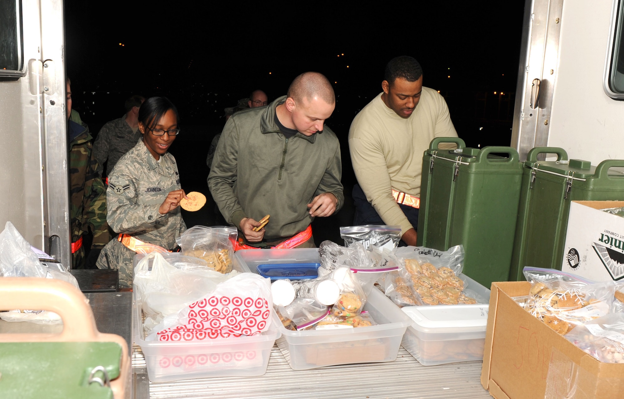 DYESS AIR FORCE BASE, Texas -- Dyess Airmen from the 7th Equipment Maintenance Squadron help themselves to some cookies and hot coco from Cookie Bus during the Operational Readiness Inspection Jan. 5. Dyess First Sergeants and Chaplains run the Cookie Bus during exercises and inspections to boost morale. (Air Force photo by Staff Sgt. Connor Estes)