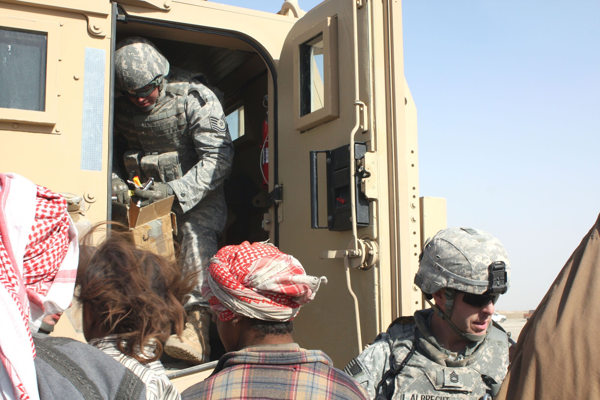 Tech. Sgt. Joseph Slysz and Army Sgt. 1st Class Kevin Albrecht sit with an Iraqi man at his home Dec. 16, 2008, outside Contingency Operating Base Adder near the city of Nasiriyah, Iraq. Sergeant Slysz is the NCO in charge of criminal intelligence for the 732nd Provost Marshal Office Det. 5. He is deployed from Edwards Air Force Base, Calif. Sergeant Albrecht is assigned to the 4th Special Troops Battalion, 4th Brigade Combat Team, 1st Cavalry Division. (U.S. Army photo/Spc. Rebekah Lampman) 
