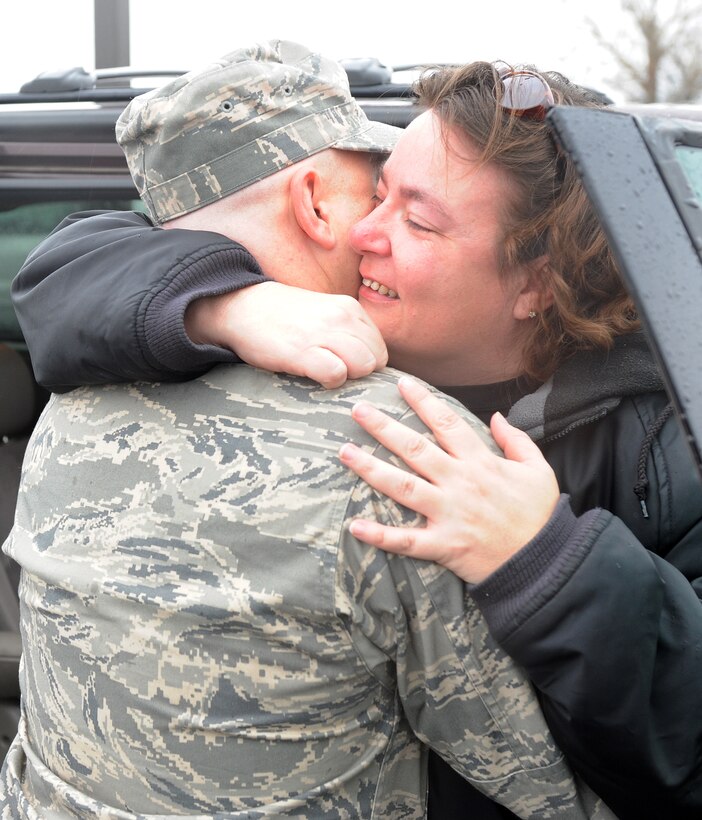 LANGLEY AIR FORCE BASE, Va. -- Staff Sgt. Christopher Murdock, 27th Fighter Squadron crew chief, hugs his wife prior to his deployment Jan. 6.  More than 250 Airmen departed Langley via commercial contract flight as part of a theater security package being sent to the Western Pacific. (U.S. Air Force photo/Airman 1st Class Zachary Wolf)