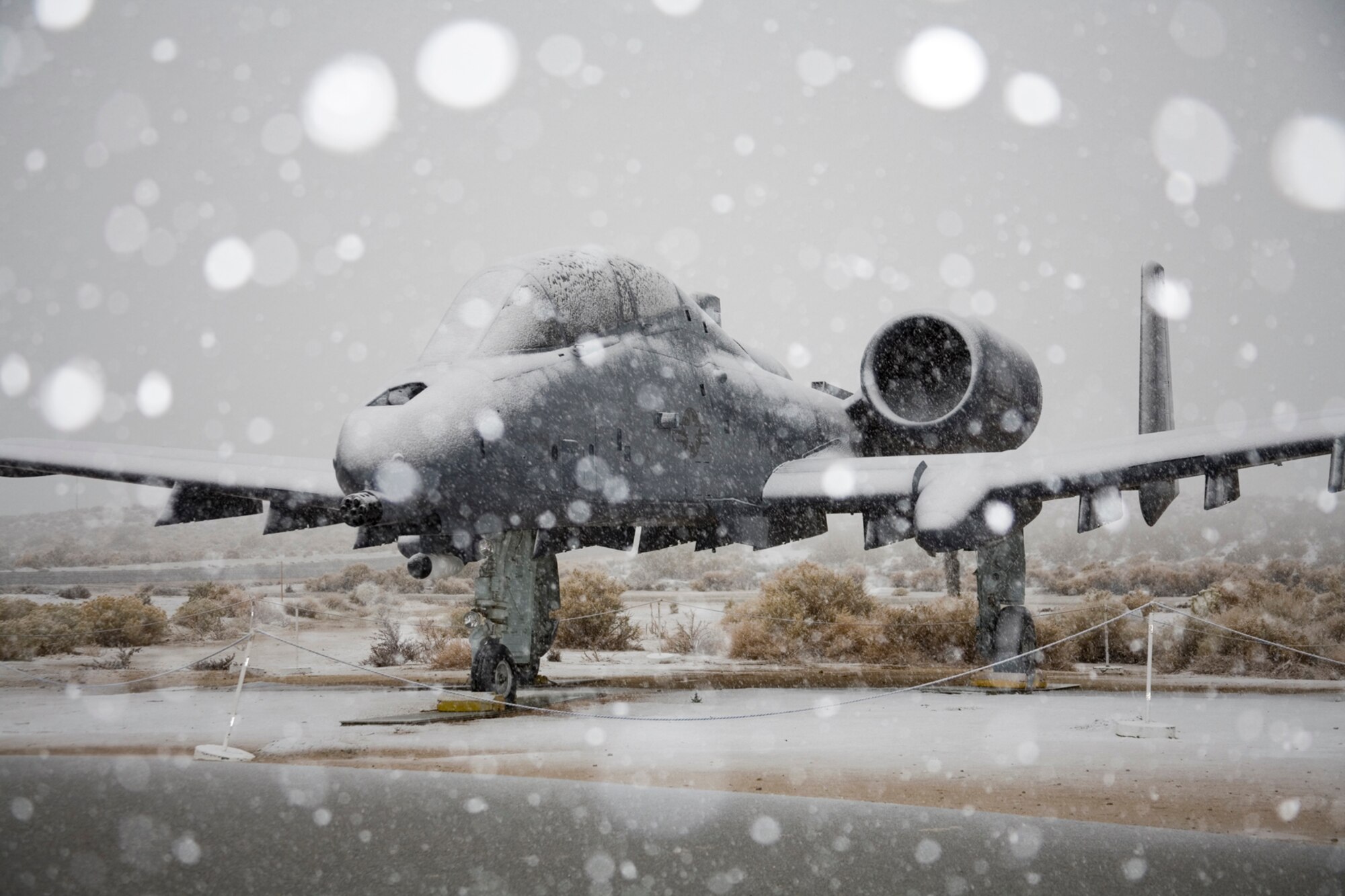 A storm pours snow over an A-10 Thunderbolt II static display at the Air Force Flight Test Center Museum Dec. 17. The base received 5 inches of snow, which affected base operations. (Air Force photo by Jet Fabara)