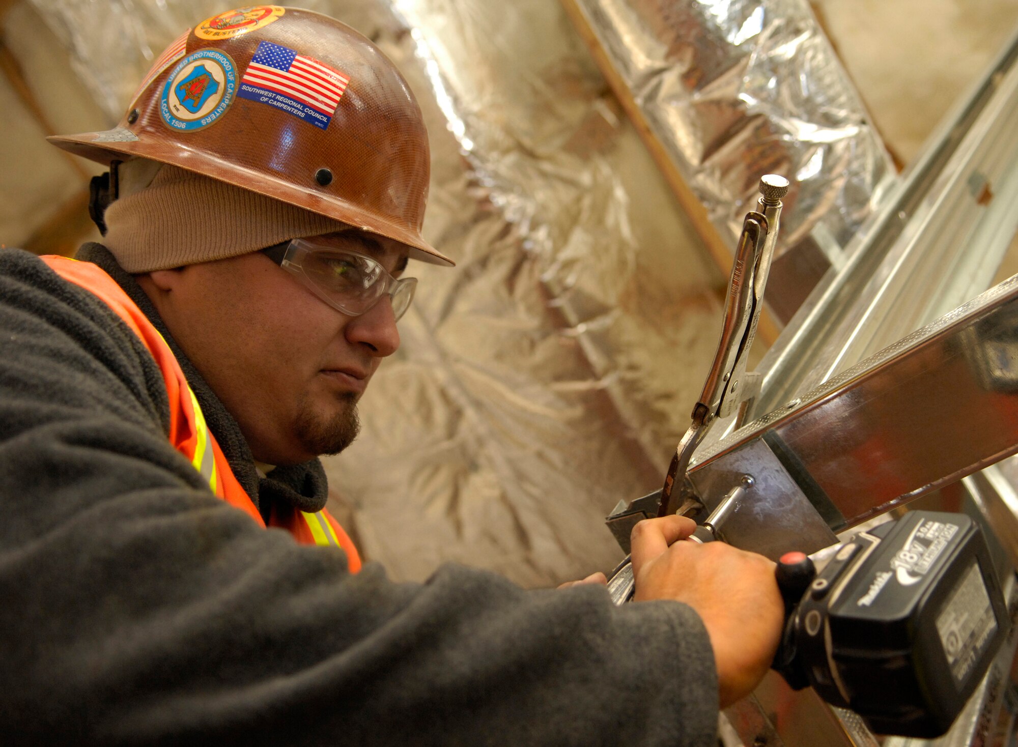 VANDENBERG AIR FORCE BASE, Calif. -- Artoro Castaneda, a construction worker with TRI County Construction, power drives in a screw to hold up the frame of a soffit for the new gym here Jan. 6. The new gym is projected to be finished in March. (U.S. Air Force photo/Airman 1st Class Christian Thomas) 
 