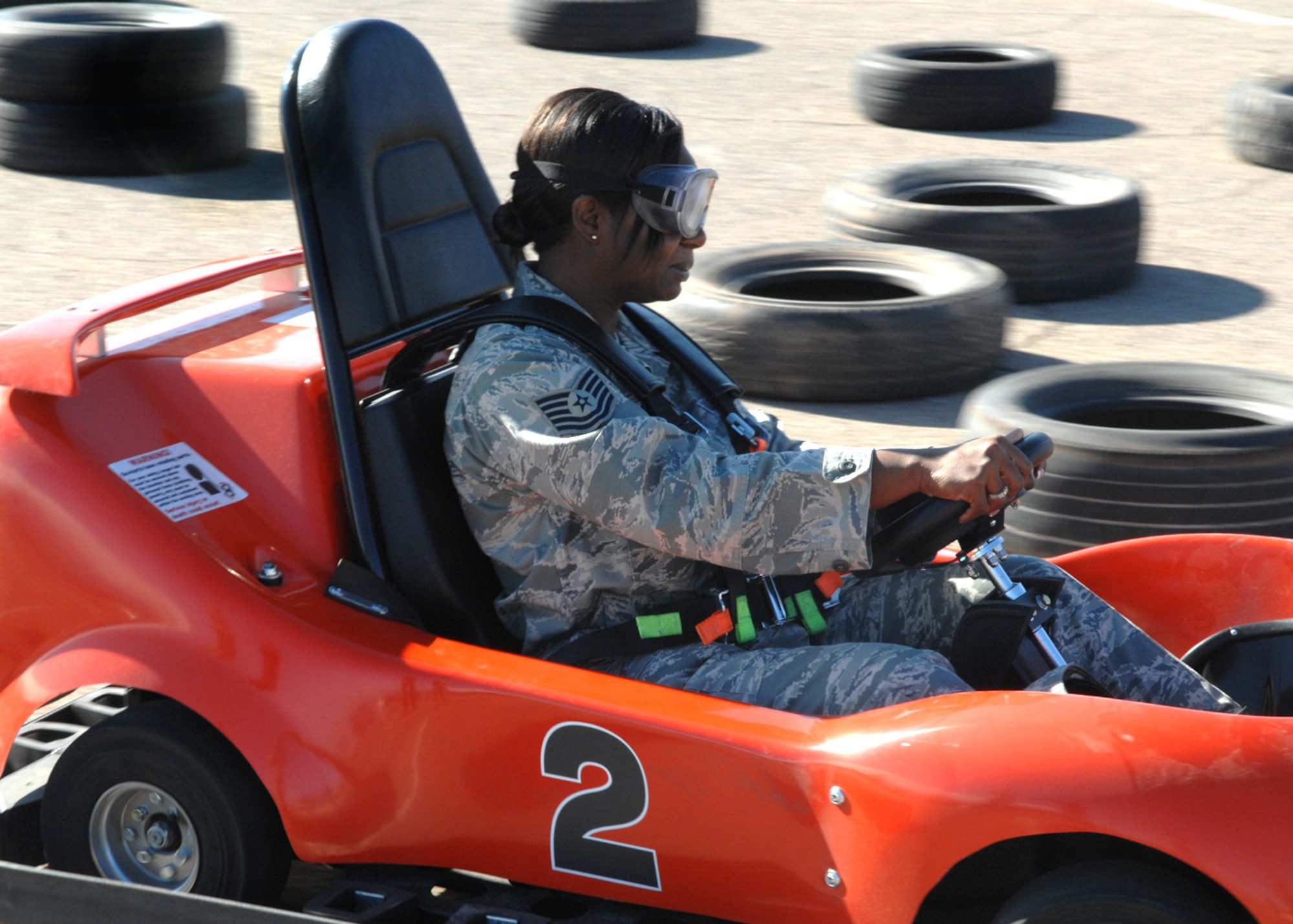 Tech. Sgt. Felicia Hamilton, 49th Fighter Wing, takes a go-kart for a spin while wearing Fatal Vision "Beer" goggles to stimulate driving under the influence at Holloman Air Force Base, N.M., Jan. 5. As part of Safety Day, Airmen got a chance to experience how driving could be after drinking. (U.S. Air Force photo/Airman 1st Class Veronica Salgado)