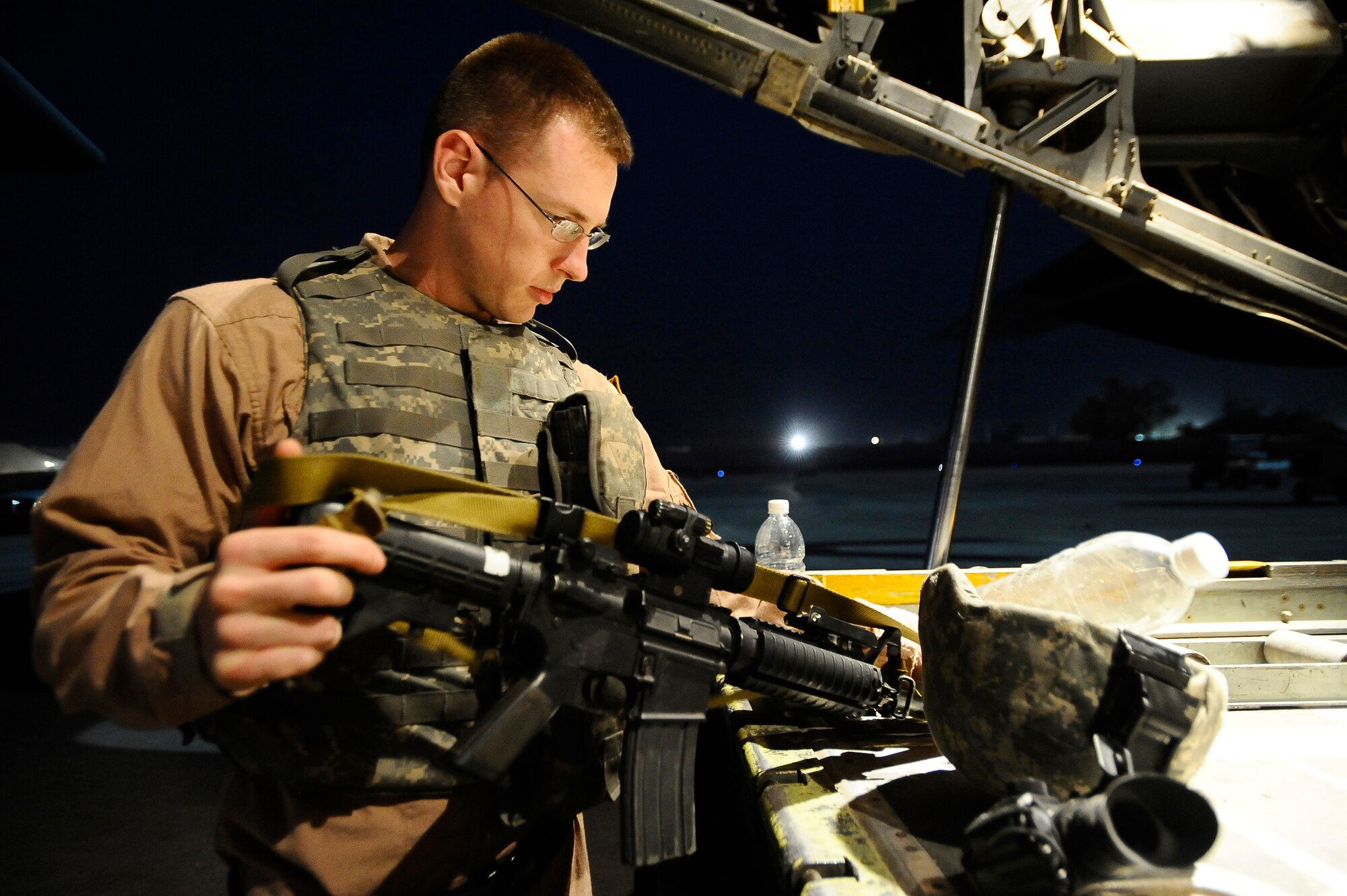 Senior Airman Matthew Rinehart checks the weapon sling on the back of a C-130 Hercules Dec. 31, 2008, at Joint Base Balad. He serves as part of the aircraft's Fly Away Security Team, which provides ground security for the aircraft as it loads and unloads cargo at unsecured airfields. Airman Rinehart, a native of York, Pa., is deployed to the 332nd Expeditionary Security Forces Team from Andrews Air Force Base, Md. (U.S. Air Force photo/Airman 1st Class Jason Epley) 
