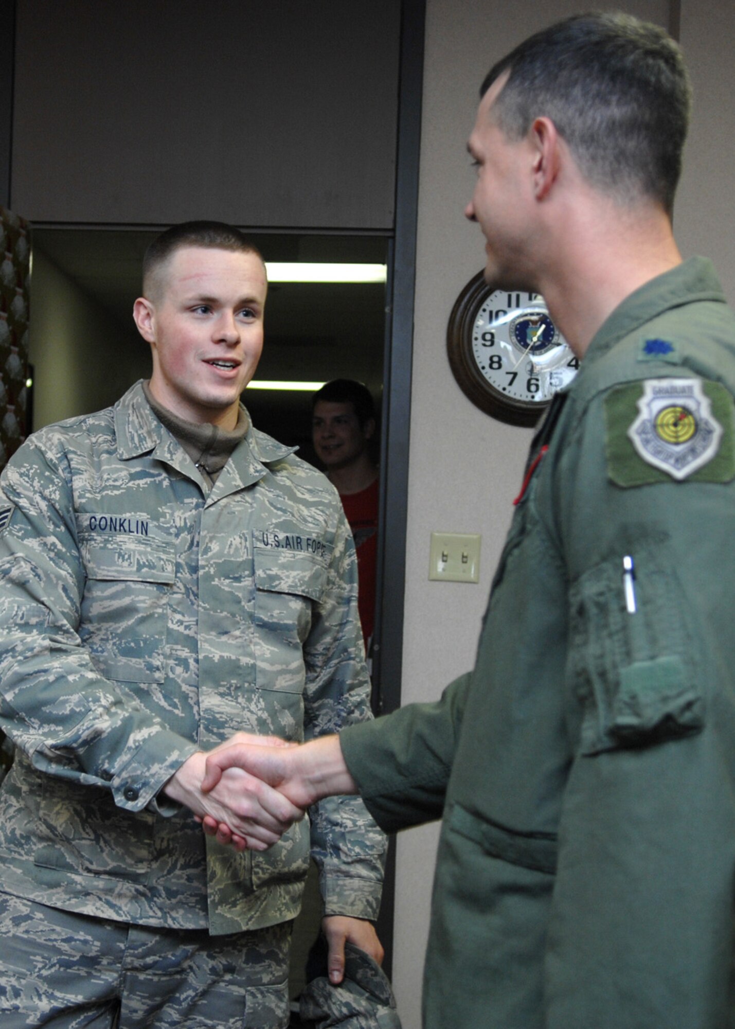 Lt. Col. Alexus Grynkewich, 49th Operations Suppport Squadron commander, welcomes home Senior Airman Thomas Conklin, also 49 OSS, on his return to Holloman Air Force Base, N.M., Jan. 5. Airman Conklin was deployed to Iraq for 179 days. (U.S. Air Force photo/Airman 1st Class Veronica Salgado)