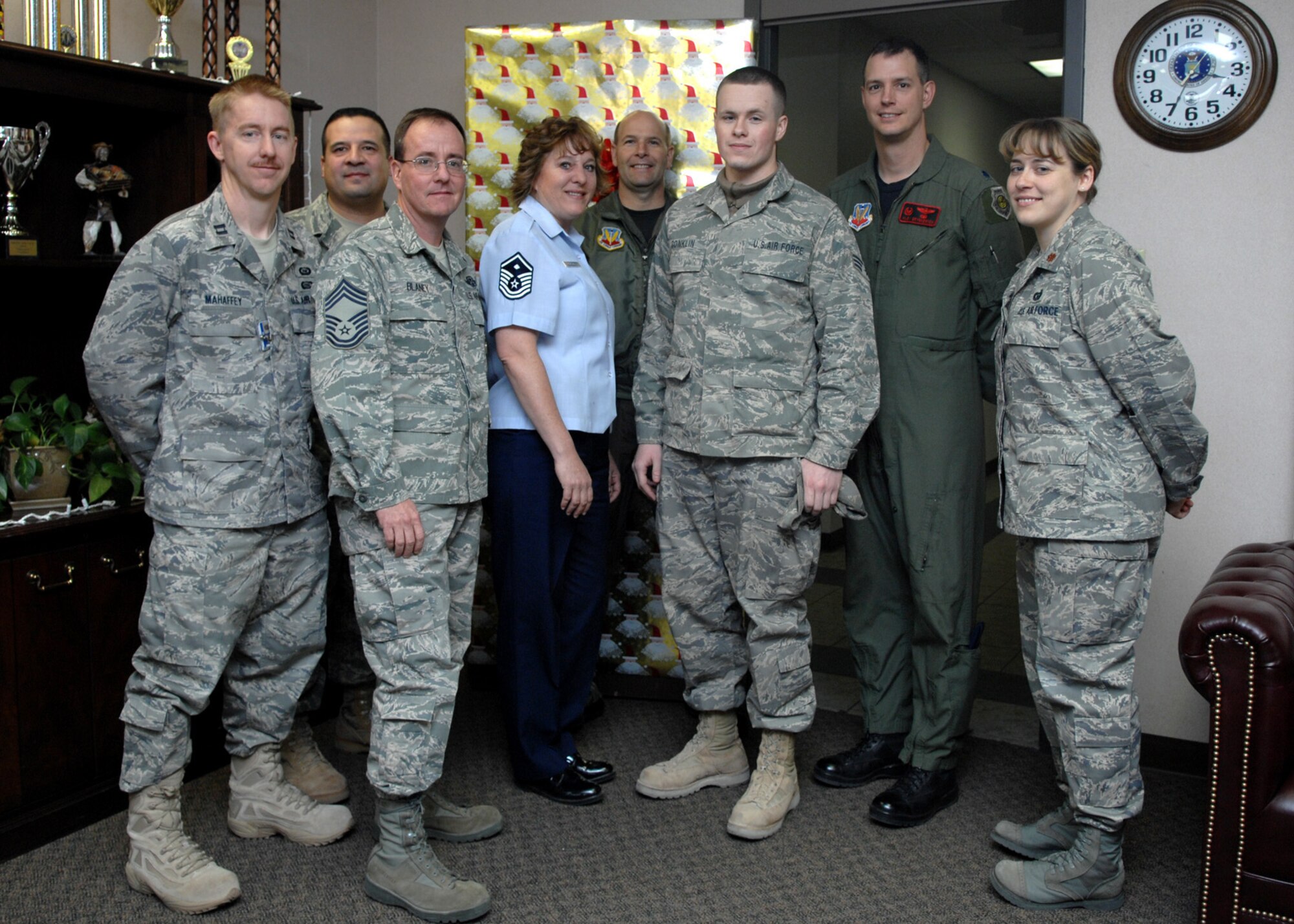Senior Airman Thomas Conklin, 49th Operations Support Squadron, poses for a group photo with other members of th 49 OSS on his return to Holloman Air Force Base, N.M., Jan. 5. Airman Conklin worked as a special programs watchkeeper during his 179-day deployment to Iraq. (U.S. Air Force photo/Airman 1st Class Veronica Salgado)