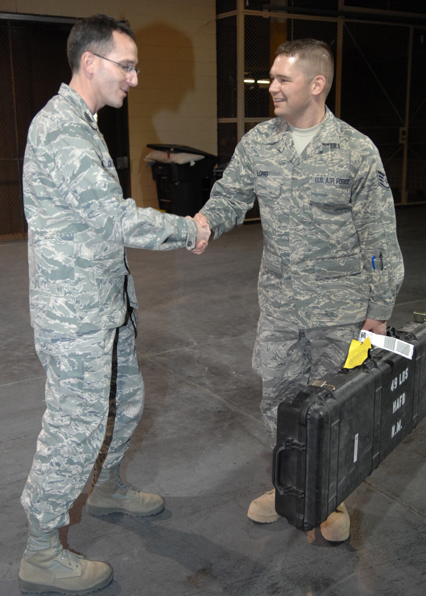 Col. Stephen DiFonzo, 49th Mission Support Group commander, greets Staff Sgt. Mike Long, 49th Logistics Readiness Squadron, on his return to Holloman Air Force Base, N.M. at the weapons vault, Dec. 31. Sergeant Long worked as a logistics planner on his six month deployment to Iraq. (U.S. Air Force photo/Airman 1st Class Veronica Salgado)