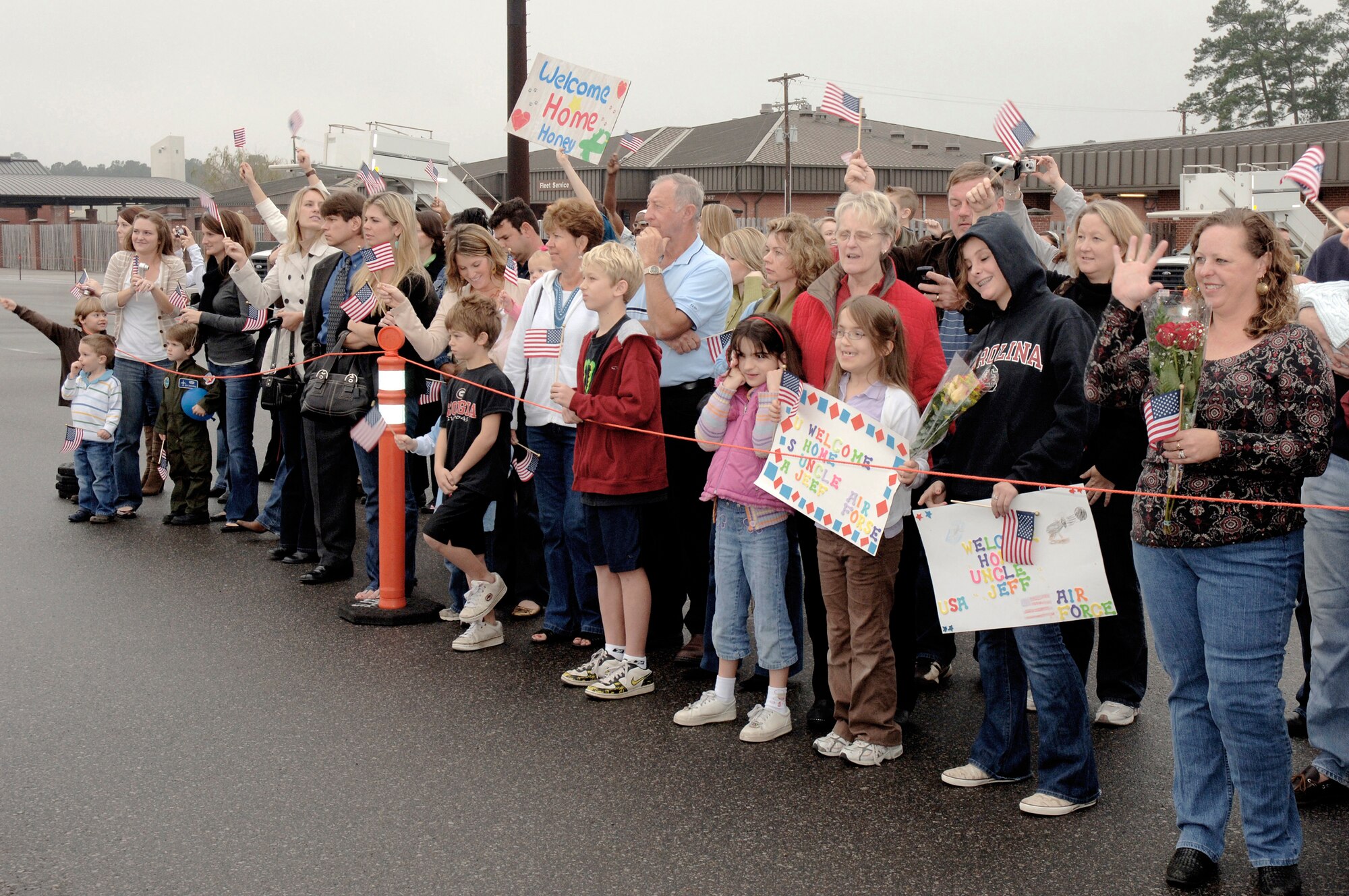 Family members cheer as they wait for the return of their loved ones from a deployment Jan. 3 at Charleston Air Force Base, S.C. More than a 130 Airmen from the 15th Airlift Squadron returned from their 120-day deployment in Southwest Asia. (U.S. Air Force photo/Staff Sgt. Marie Cassetty)
