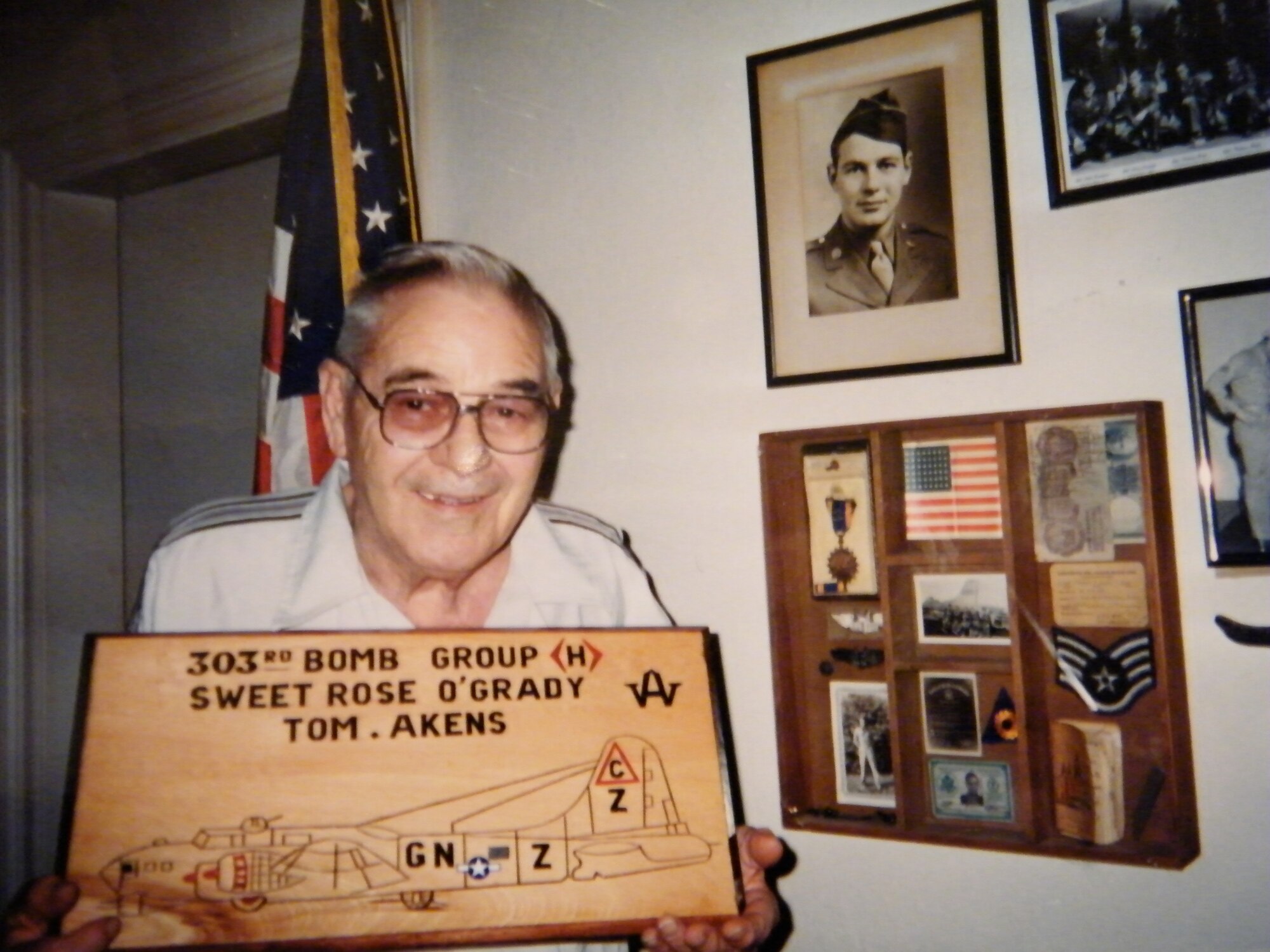 Sergeant Thomas I. Akens who served at Molesworth in 1945 during the Second World War, displays a wood plaque created by the British wood carver Bill Adams.  Several plaques by Mr. Adams are displayed on the walls of the EUCOM Joint Analytic Center at RAF Molesworth.  Ms. Kelly Akens, grandaughter of Sergeant Akens visited  RAF Molesworth, England on November 7th visit. (Photo Courtesy of Ms. Akens)
