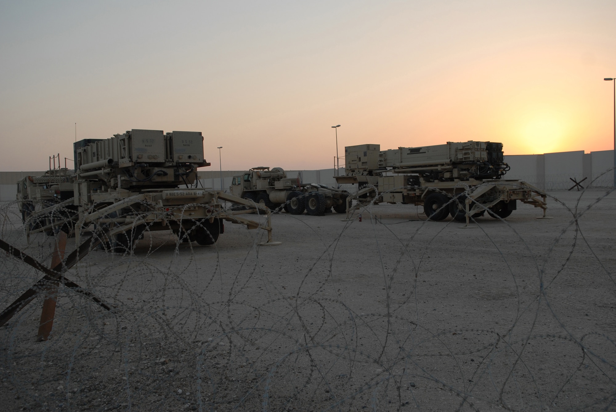 Two Patriot PAC 3 launchers stand ready for their new mission Jan. 2 at an air base in Southwest Asia. More than a dozen Soldiers deployed to the Air Force base to prepare the Patriot equipment before the arrival of the main body from 5-52 Air Defense Artillery Battalion from Fort Bliss, Texas. (U.S. Air Force photo/Tech. Sgt. Denise Johnson) 
