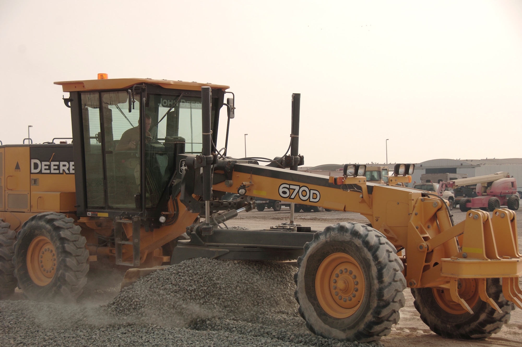 Staff Sgt. Shane Newell uses a motor grader to spread fill material to build up and stabilize the sub-base prior to placing base course gravel Sept. 16 at an air base in Southwest Asia. Airmen are preparing an area for Soldiers from the 5-52 Air Defense Artillery Battalion of Fort Bliss, Texas. Sergeant Newell is assigned to the the 380th Expeditionary Civil Engineer Squadron and deployed from Ramstein Air Base, Germany. His hometown is Orlando, Fla. (U.S. Air Force photo/Tech. Sgt. Christopher A. Campbell) 