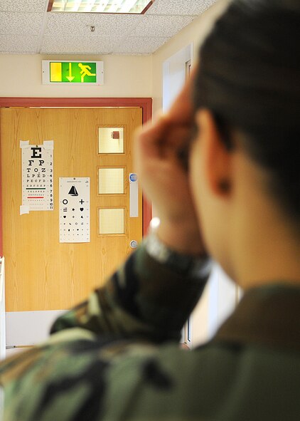 Airman 1st Class Bridget Williams, an aerospace medical technician apprentice from the 48th Aerospace Medical Squadron, demonstrates the proper way to perform an eye examination during a preventive health assessment exam Dec. 16, 2008, at RAF Mildenhall, England. (U.S. Air Force photo by Staff Sgt. Jerry Fleshman)