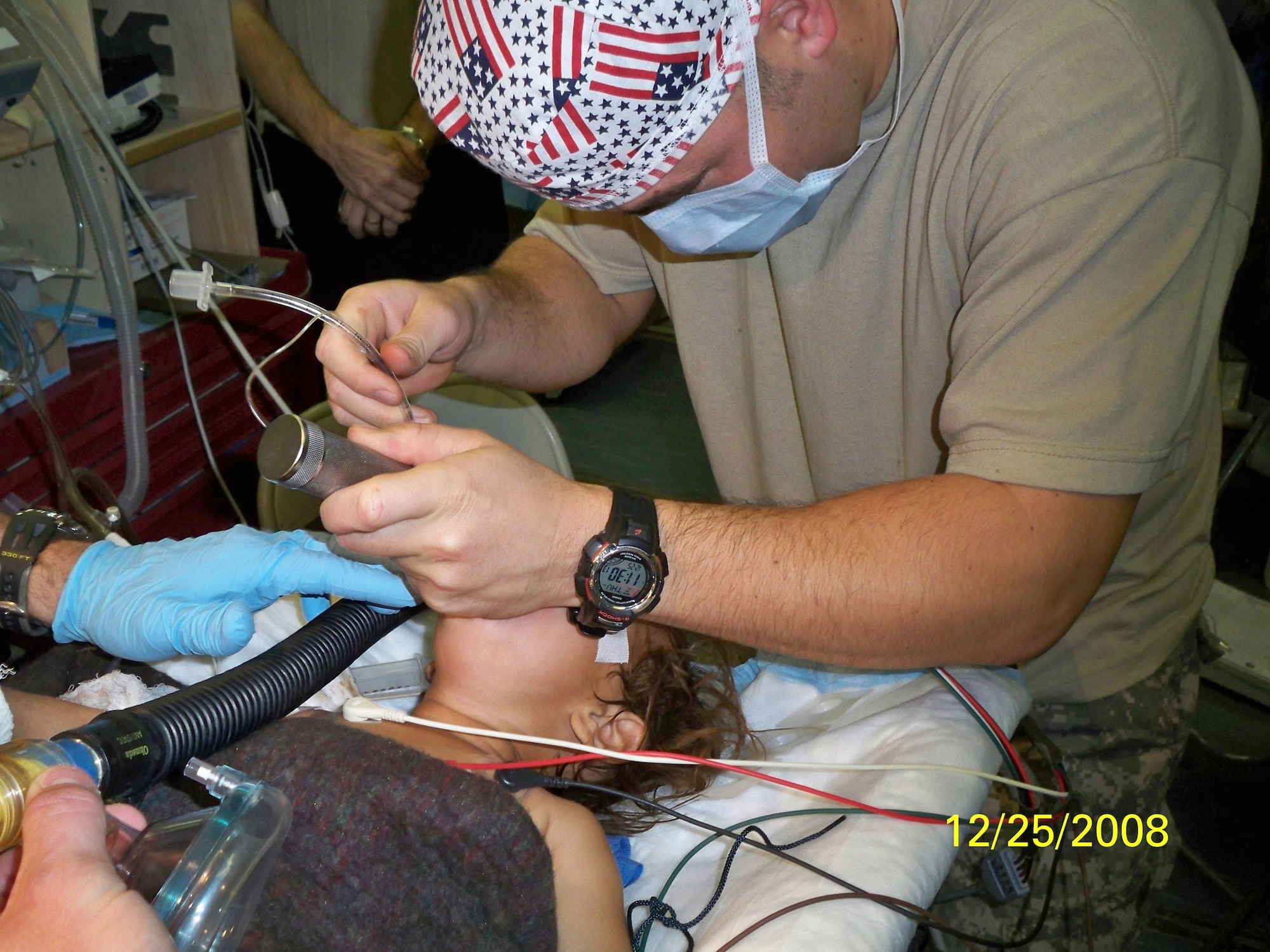Army Capt. John Gasko  administers anesthetics  to a local girl during a Christmas Day surgery. The Field Surgical Team performed skin grafts on two small Afghan girls who were burned in a local village. (Courtesy Photo)