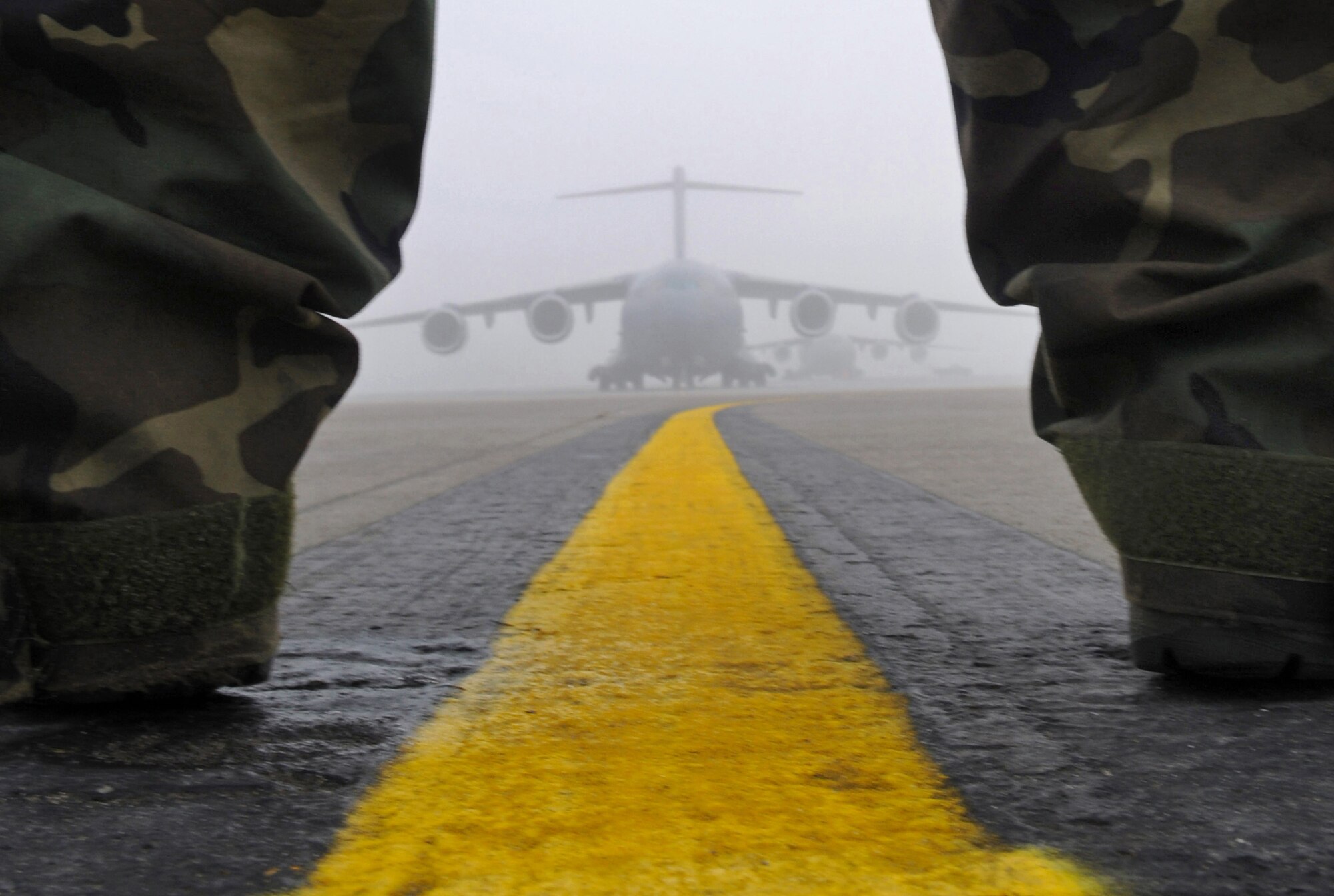 Staff Sgt. Jason Kennedy, 721st Air Mobility Squadron, marshalls a C-17 Globemaster III preparing to take off from Ramstein Air Base, Germany, Dec. 24, 2008. (U.S. Air Force photo by Airman 1st Class Grovert Fuentes-Contreras)
