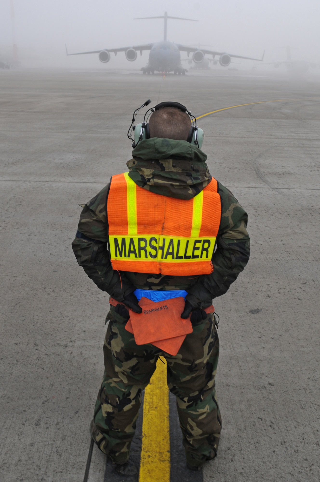 Staff Sgt. Jason Kennedy, 721st Air Mobility Squadron, marshalls a C-17 Globemaster III preparing to take off from Ramstein Air Base, Germany, Dec. 24, 2008. (U.S. Air Force photo by Airman 1st Class Grovert Fuentes-Contreras)