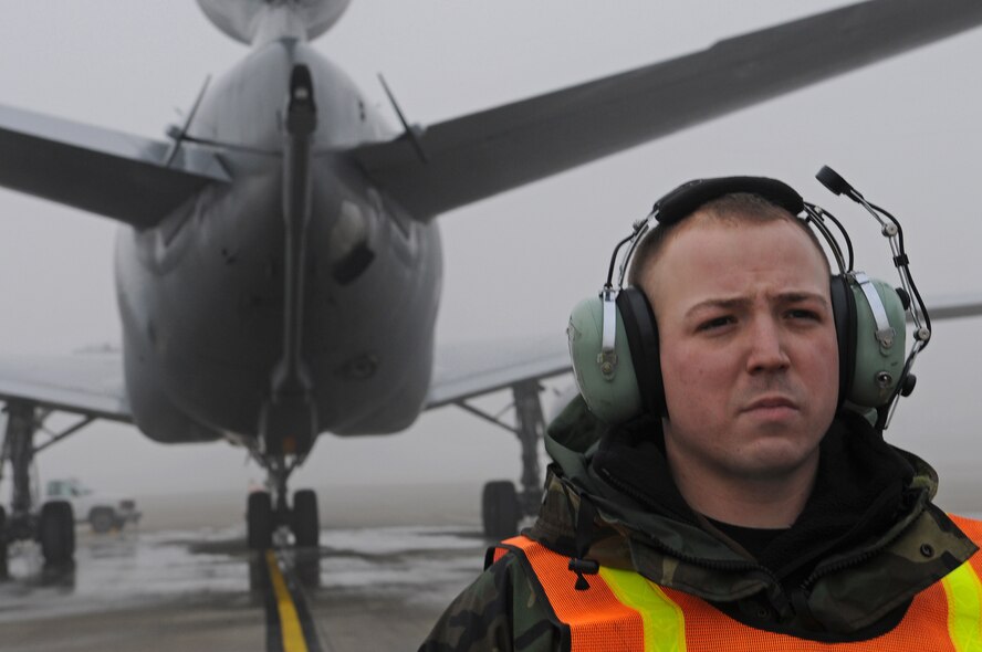 Staff Sgt. Jason Kennedy, 721st Air Mobility Squadron, waits for the command to marshall a C-17 Globemaster III ready to take off from Ramstein Air Base, Germany, Dec. 24, 2008. (U.S. Air Force photo by Airman 1st Class Grovert Fuentes-Contreras)