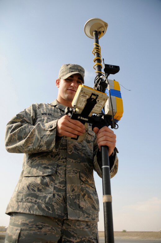 SOUTHWEST ASIA -- Airman 1st Class Ryan Nolan from the 380th Expeditionary Civil Engineer Squadron surveys land around a recently moved structure here. Airman Nolan is using a Trimble Survey Rover to perform this operation. The rover uses triangulation with a base station to set coordinates for a base map and allows for up to .01m accuracy of base assets. Airman Nolan performs this task for a variety of purposes such as construction of a maintenance pad and new dormitories in preparation for the arrival of Soldiers from the 5-52 Air Defense Artillery Battalion, Fort Bliss, Texas. Airman Nolan is deployed from the 75th CES Ramstein Air Base, Germany. His hometown is Pekin, Ill. (U.S. Air Force photo/ Tech. Sgt. Christopher A. Campbell) (released)