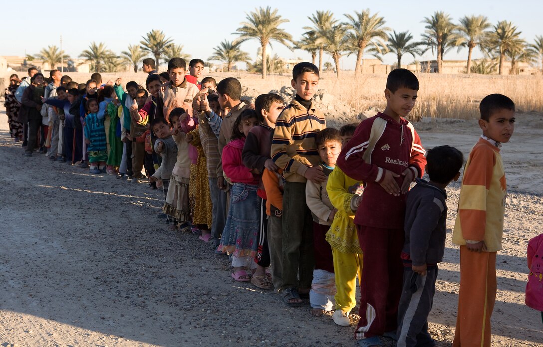 Marines of Task Force 1st Battalion, 3rd Marine Regiment, Regimental Combat Team 1, distributed jackets and shoes to children in Karmah, Iraq, Jan. 6. The clothing was donated by various charitable organizations throughout the U.S. and arrived in time to help keep children warm during Iraq's colder months.
