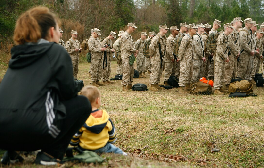 Family members watch as Marines and sailors of Regimental Combat Team 8 assemble into one of their final formations here before departing to al Asad, Iraq, Jan. 6. RCT-8, under the command of II Marine Expeditionary Force (Forward), is on their second deployment in support of Operation Iraqi Freedom. (Official U.S. Marine Corps photo by Cpl. Joshua Murray) (RELEASED)